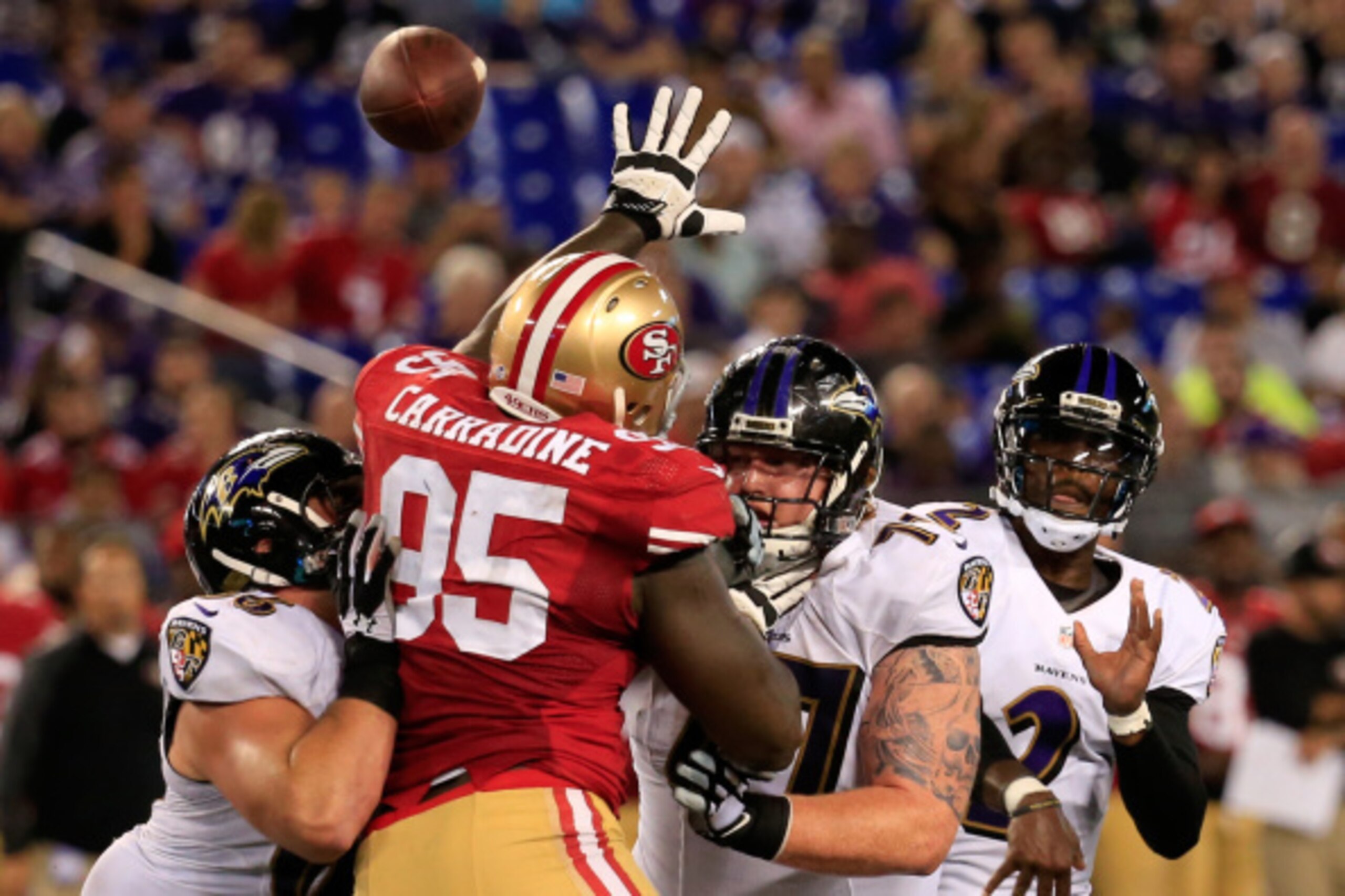 BALTIMORE, MD - AUGUST 07: Quarterback Tyrod Taylor #2 of the Baltimore Ravens throws a pass while defensive end Cornellius Carradine #95 of the San Francisco 49ers tries to knock it down during the first half of an NFL pre-season game at M&T Bank Stadium