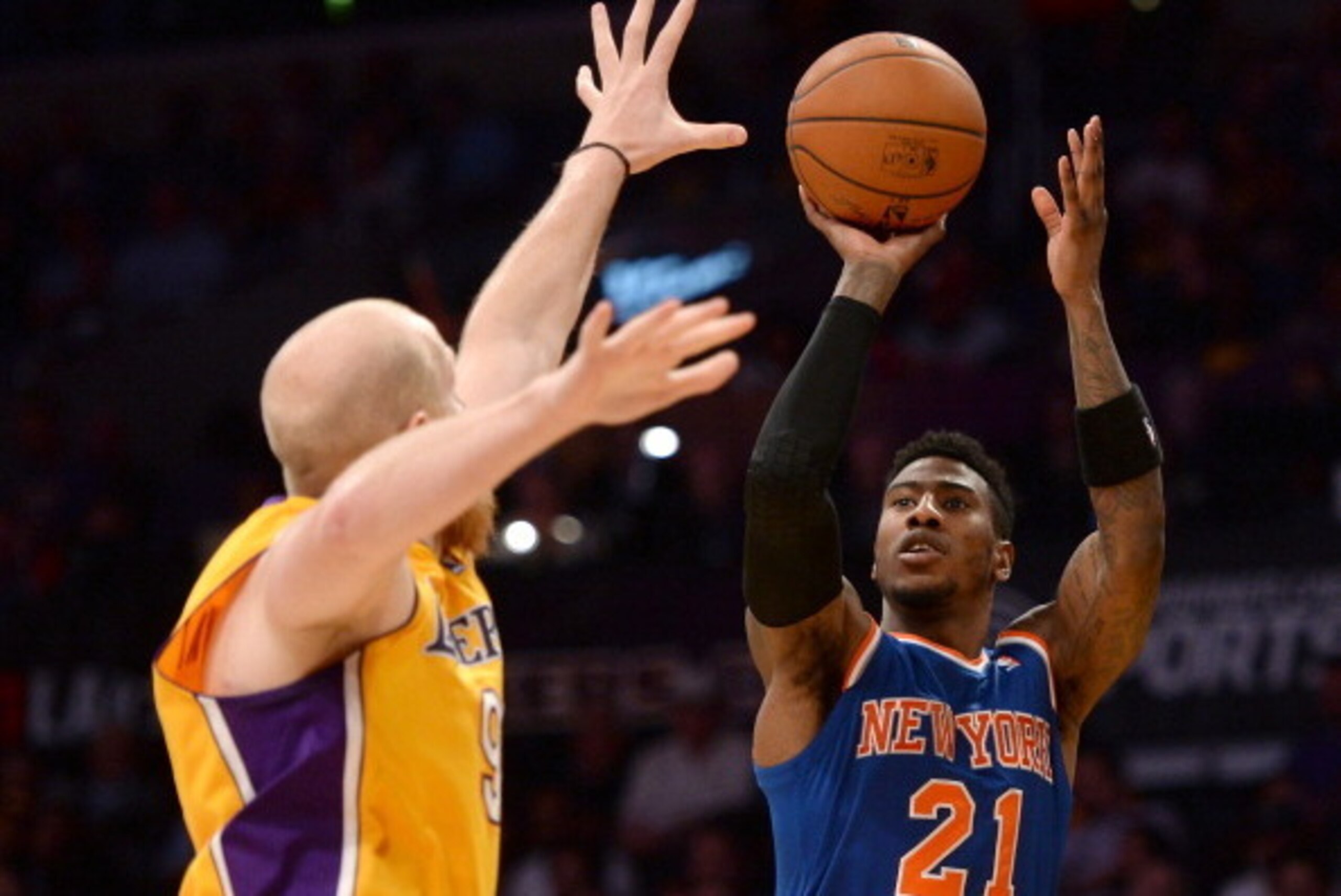 LOS ANGELES, CA - MARCH 25:  Iman Shumpert #21 of the New York Knicks shoots over the hands of Chris Kaman #9 of the Los Angeles Lakers at Staples Center on March 25, 2014 in Los Angeles, California.   NOTE TO USER: User expressly acknowledges and agrees 