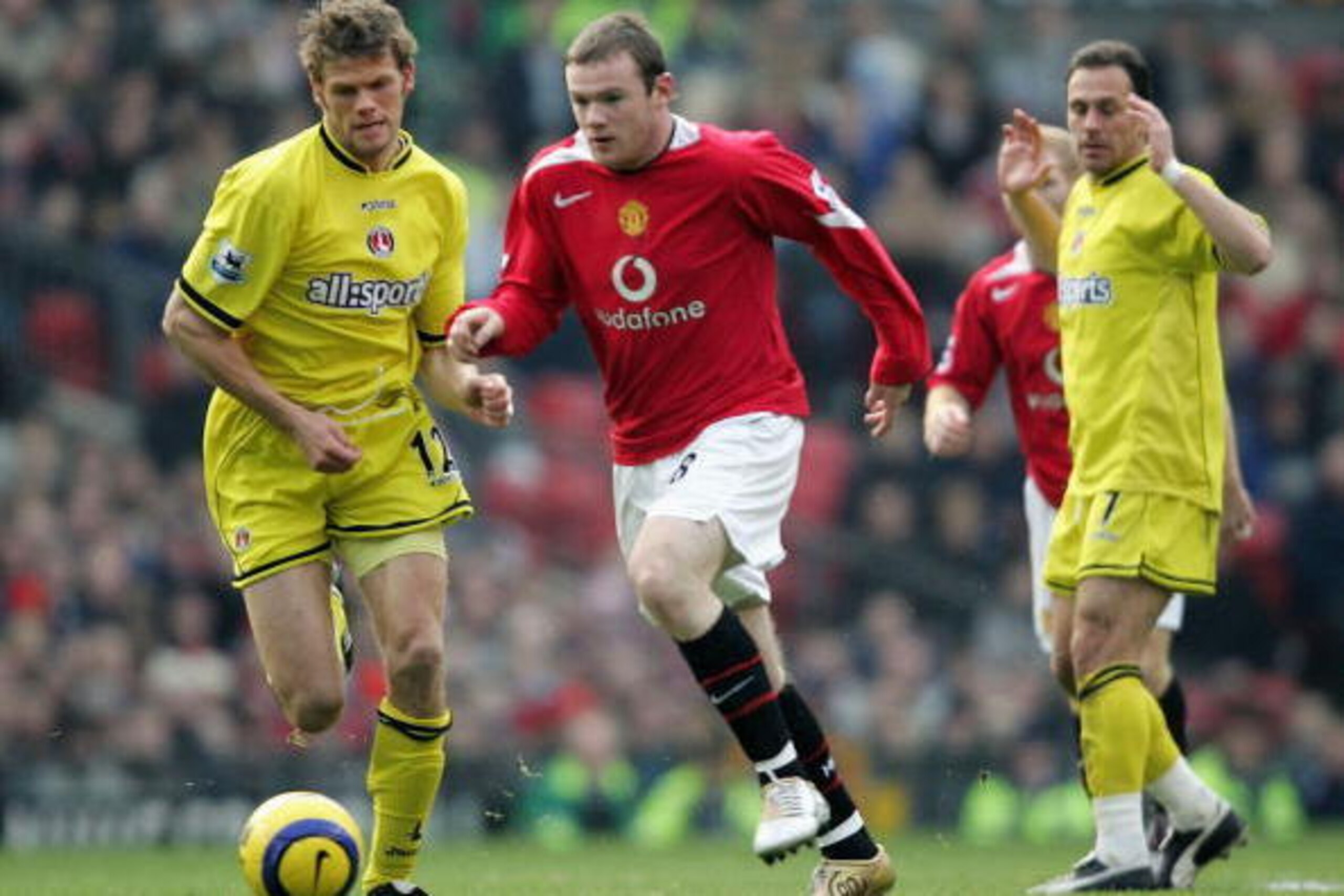 MANCHESTER, ENGLAND - NOVEMBER 20:  Wayne Rooney of Manchester goes past Hermann Hreidarsson of Charlton during the Barclays Premiership match between Manchester United and Charlton Athletic at Old Trafford, on November 20, 2004 in Manchester, England.  (