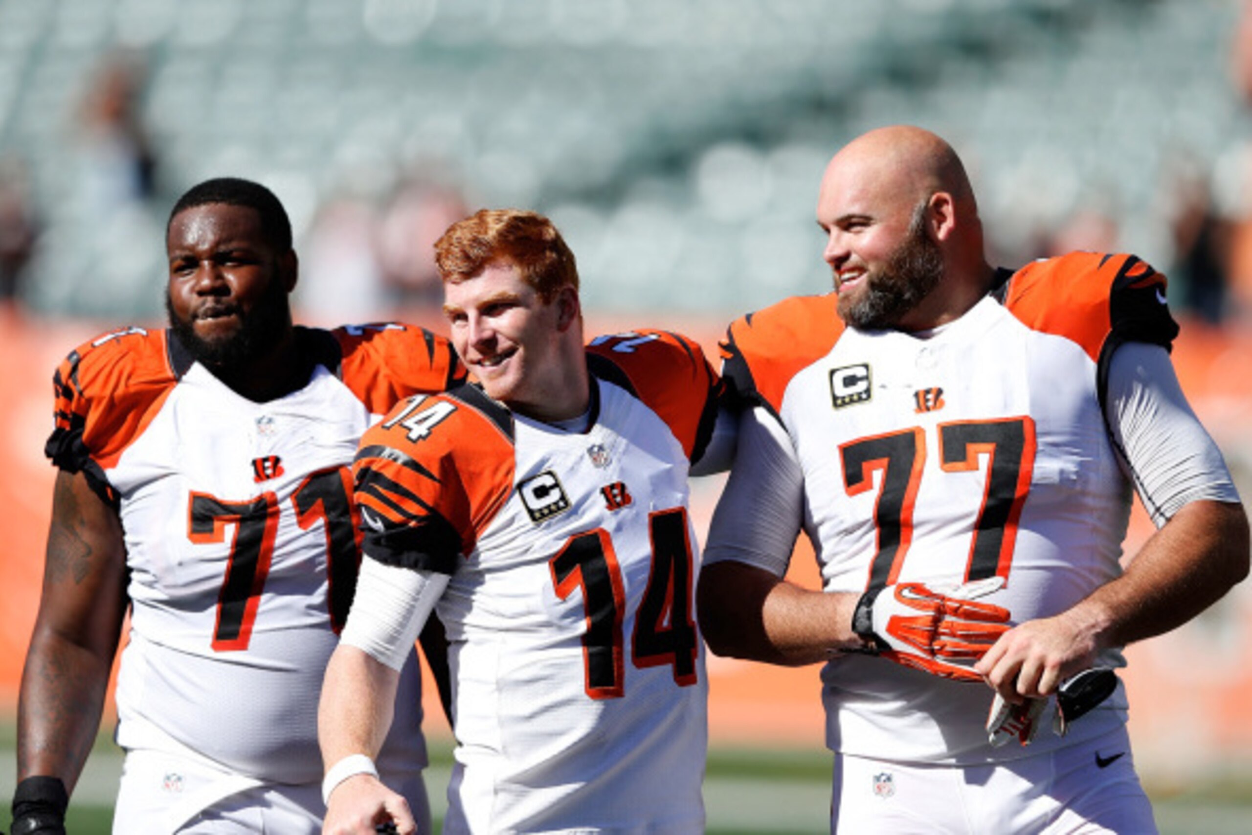 CINCINNATI, OH - SEPTEMBER 14:  Andre Smith #71, Andy Dalton #14, and Andrew Whitworth #77, all of the Cincinnati Bengals, walk off of the field after defeating the Atlanta Falcons 24-10 at Paul Brown Stadium on September 14, 2014 in Cincinnati, Ohio. (Ph