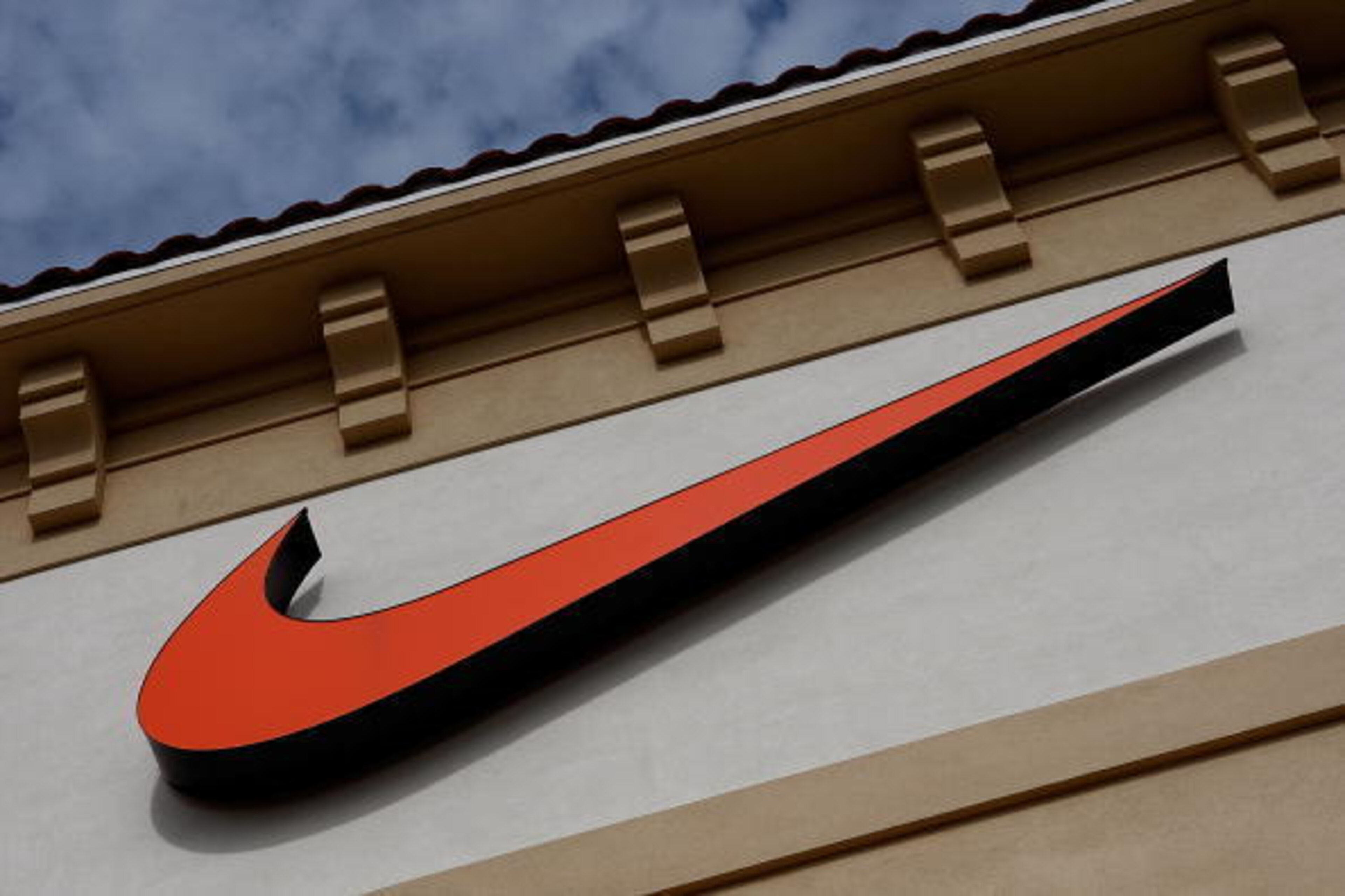 ORLANDO, FL - DECEMBER 12: The 'Swoosh' logo is seen on a Nike factory store on December 12, 2009 in Orlando, Florida. Tiger Woods announced that he will take an indefinite break from professional golf to concentrate on repairing family relations after ORLANDO, FL - DECEMBER 12: The 'Swoosh' logo is seen on a Nike factory store on December 12, 2009 in Orlando, Florida. Tiger Woods announced that he will take an indefinite break from professional golf to concentrate on repairing family relations after