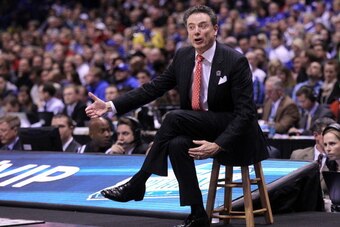 INDIANAPOLIS, IN - MARCH 28:  Head coach Rick Pitino of the Louisville Cardinals shouts to his team against the Kentucky Wildcats during the regional semifinal of the 2014 NCAA Men's Basketball Tournament at Lucas Oil Stadium on March 28, 2014 in Indianap