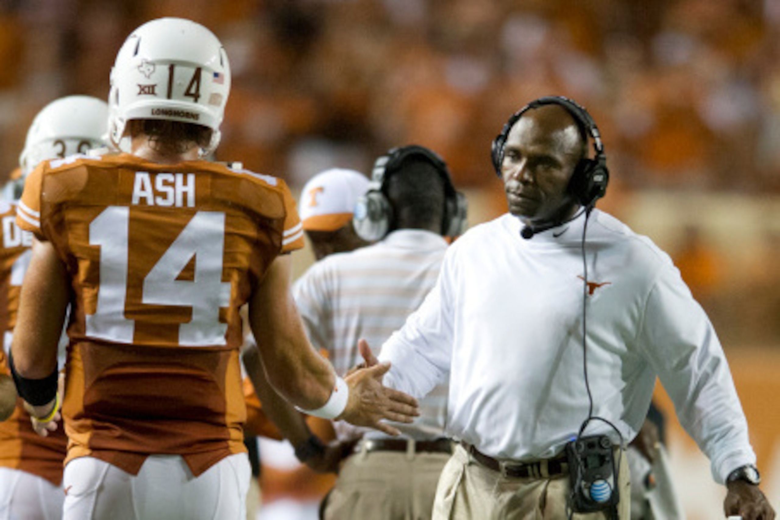 AUSTIN, TX - AUGUST 30:  Texas Longhorns head coach Charlie Strong congratulates quarterback David Ash #14 after throwing a touchdown against the North Texas Mean Green during the third quarter on August 30, 2014 at Darrell K Royal-Texas Memorial Stadium 