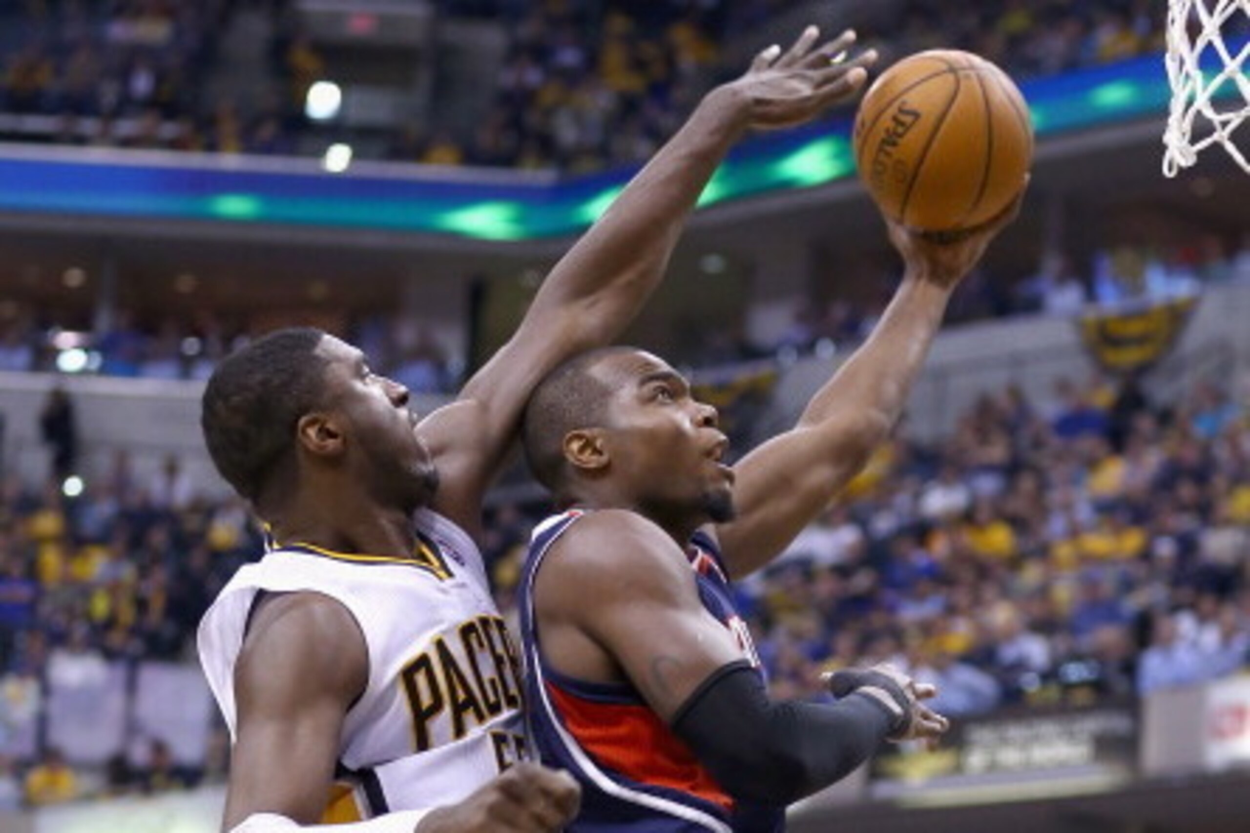 INDIANAPOLIS, IN - APRIL 22: Roy Hibbert #55 of the Indiana Pacers defends the shot of Paul Milsap #4 of the Atlanta Hawks in Game 2 of the Eastern Conference Quarterfinals during the 2014 NBA Playoffs at Bankers Life Fieldhouse on April 22, 2014 in India