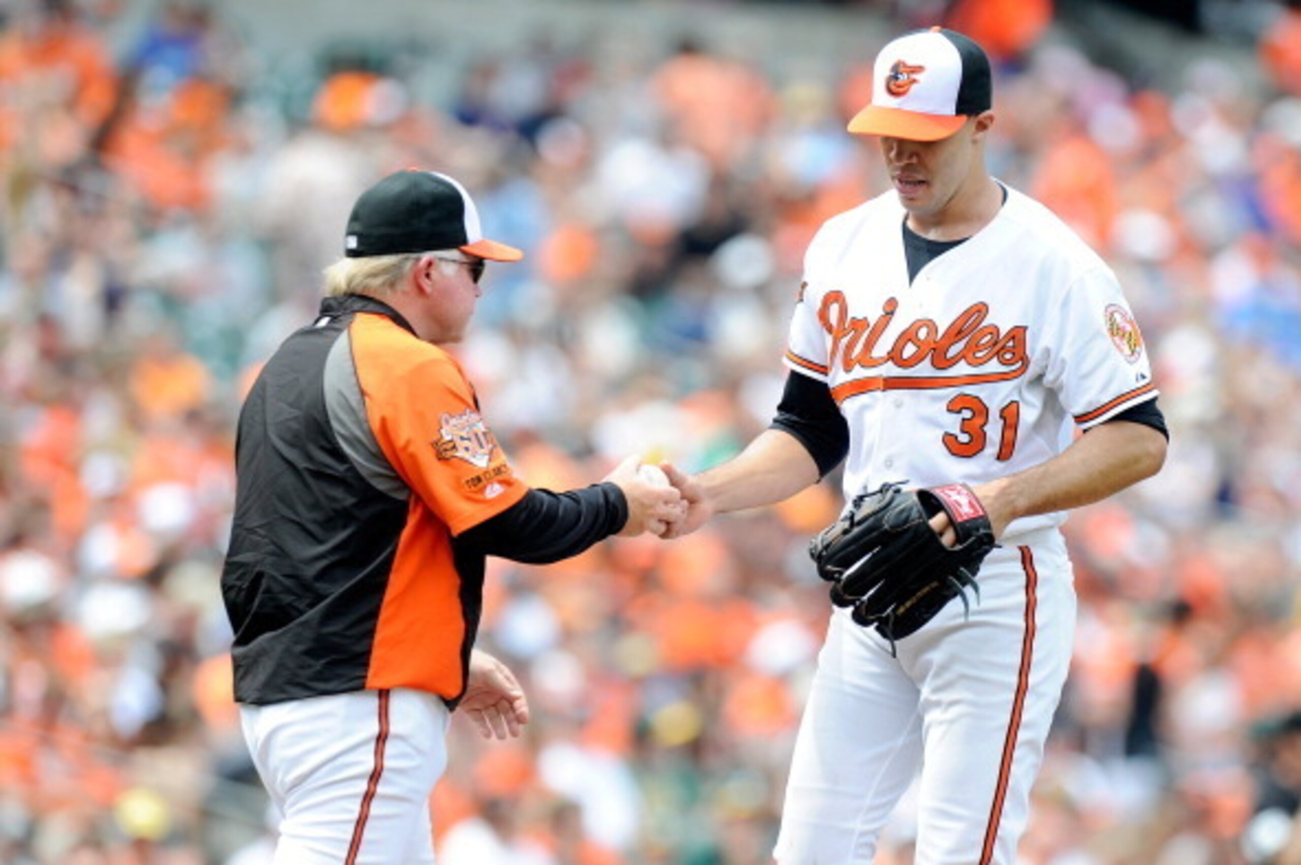 BALTIMORE, MD - JUNE 08:  Ubaldo Jimenez #31 of the Baltimore Orioles is removed from the game by manager Buck Showalter #26 in the third inning against the Oakland Athletics at Oriole Park at Camden Yards on June 8, 2014 in Baltimore, Maryland.  (Photo b