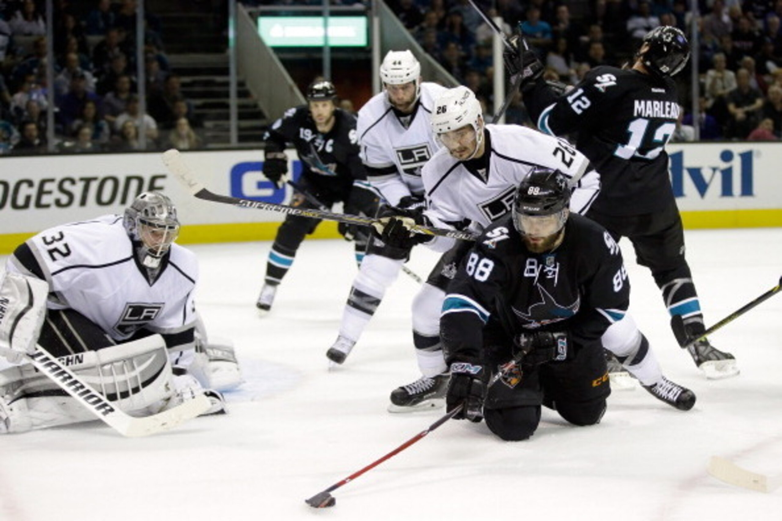 SAN JOSE, CA - APRIL 30:  Slava Voynov #26 and goalie Jonathan Quick #32 of the Los Angeles Kings stop Brent Burns #88 of the San Jose Sharks from scoring in Game Seven of the First Round of the 2014 NHL Stanley Cup Playoffs at SAP Center on April 30, 201