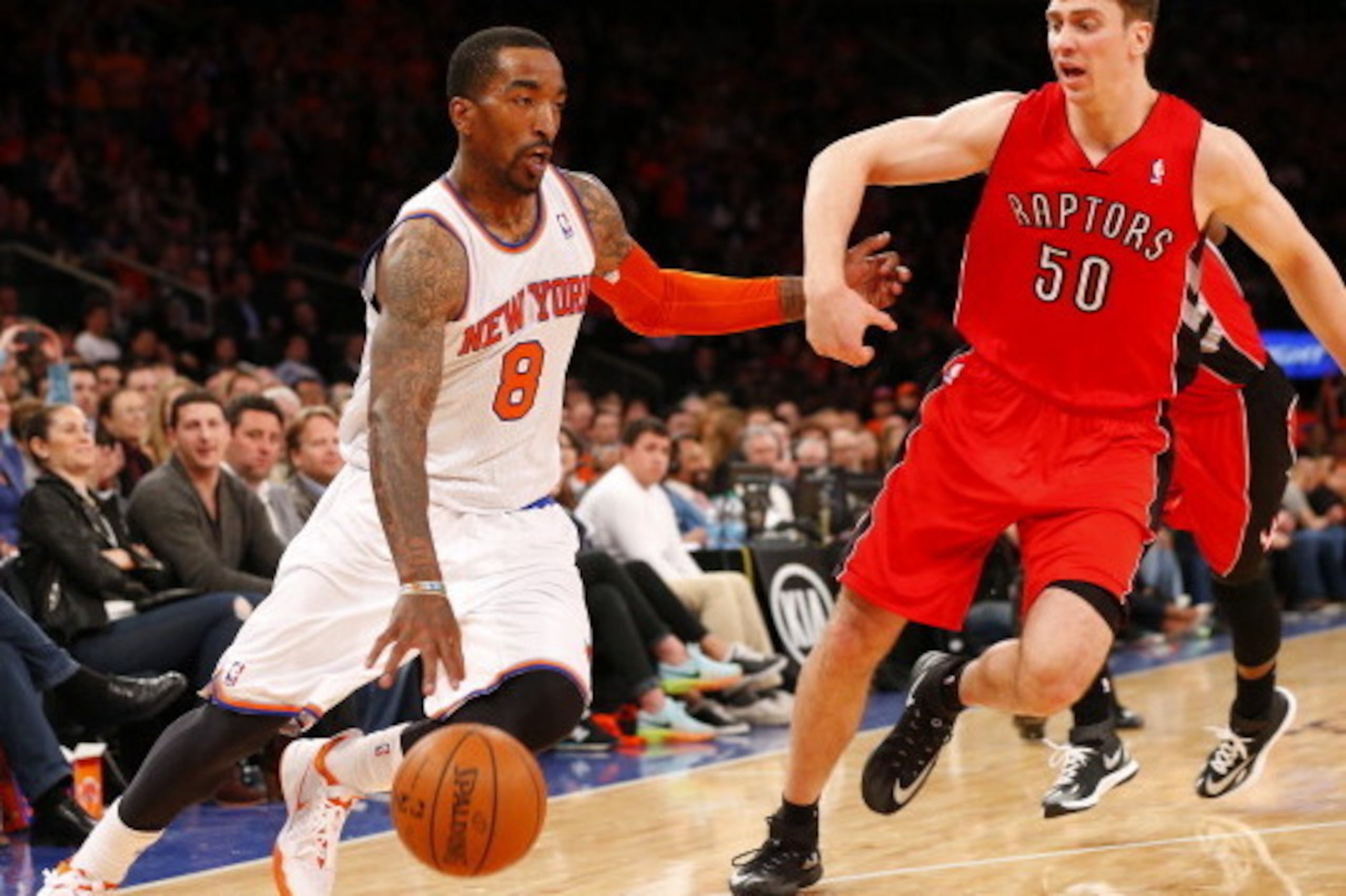 NEW YORK, NY - APRIL 16: J.R. Smith #8 of the New York Knicks is defended by Tyler Hansbrough #50 of the Toronto Raptors in the second half during an NBA basketball game at Madison Square Garden on April. 16, 2014 in New York City. The Knicks defeated the NEW YORK, NY - APRIL 16: J.R. Smith #8 of the New York Knicks is defended by Tyler Hansbrough #50 of the Toronto Raptors in the second half during an NBA basketball game at Madison Square Garden on April. 16, 2014 in New York City. The Knicks defeated the