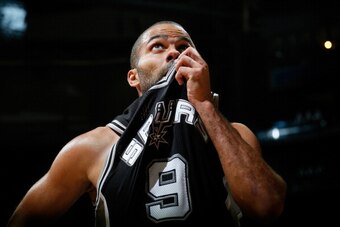 ATLANTA, GA - OCTOBER 17:  Tony Parker #9 of the San Antonio Spurs wipes sweat from his face during a timeout against the Atlanta Hawks at Philips Arena on October 17, 2013 in Atlanta, Georgia.  NOTE TO USER: User expressly acknowledges and agrees that, b