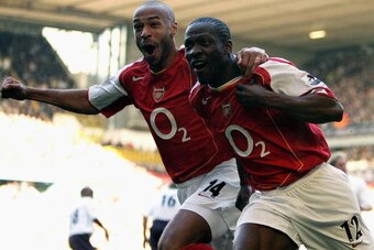 LONDON - NOVEMBER 13:  Lauren of Arsenal (R) celebrates with Thierry Henry during the Barclays Premiership match between Tottenham Hotspur and Arsenal at White Hart Lane on November 13, 2004 in London, England.  (Photo by Ian Walton/Getty Images)