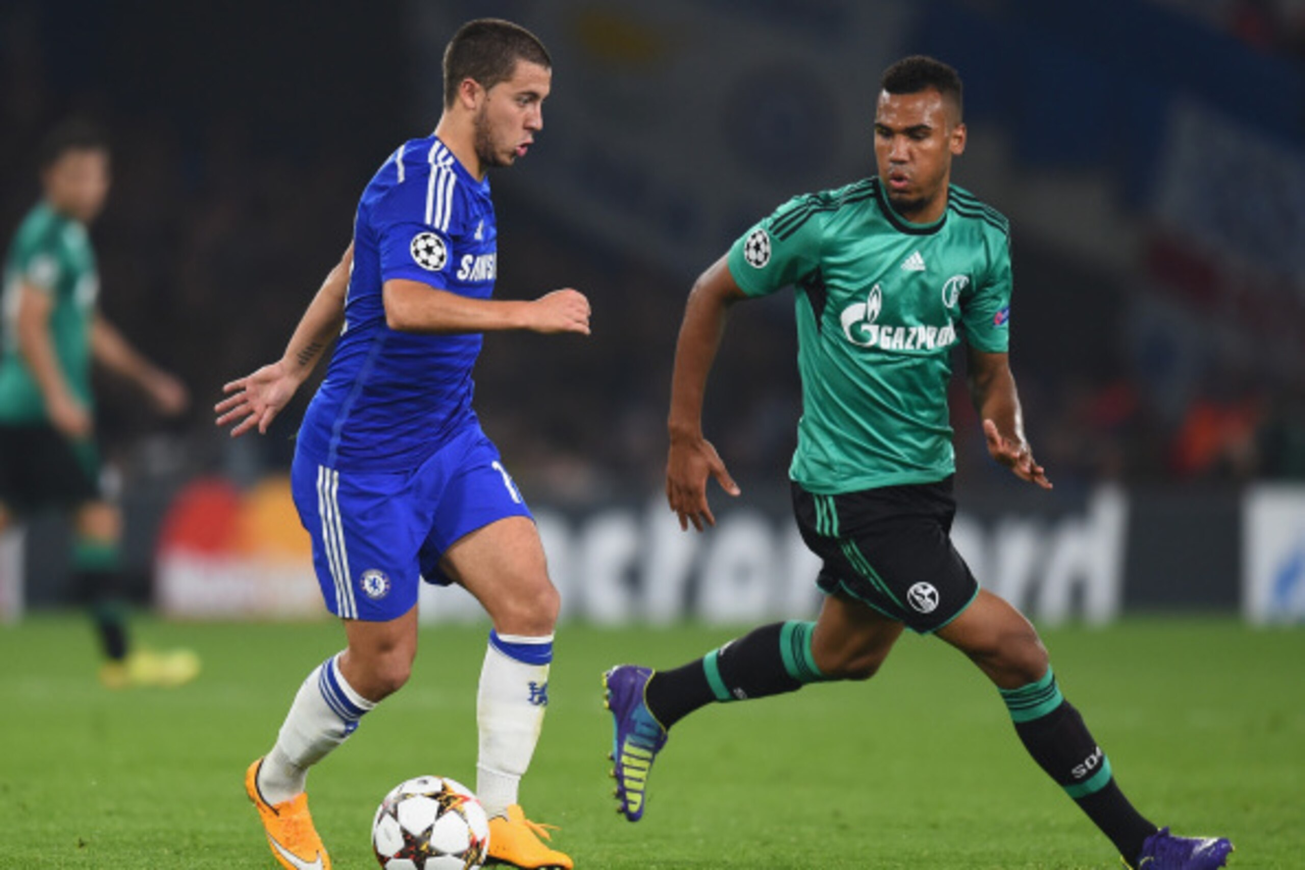 LONDON, ENGLAND - SEPTEMBER 17:  Eden Hazard of Chelsea is challenged by Eric Maxim Choupo-Moting of Schalke during the UEFA Champions League Group G match between Chelsea FC and FC Schalke 04 on September 17, 2014 in London, United Kingdom.  (Photo by Mi