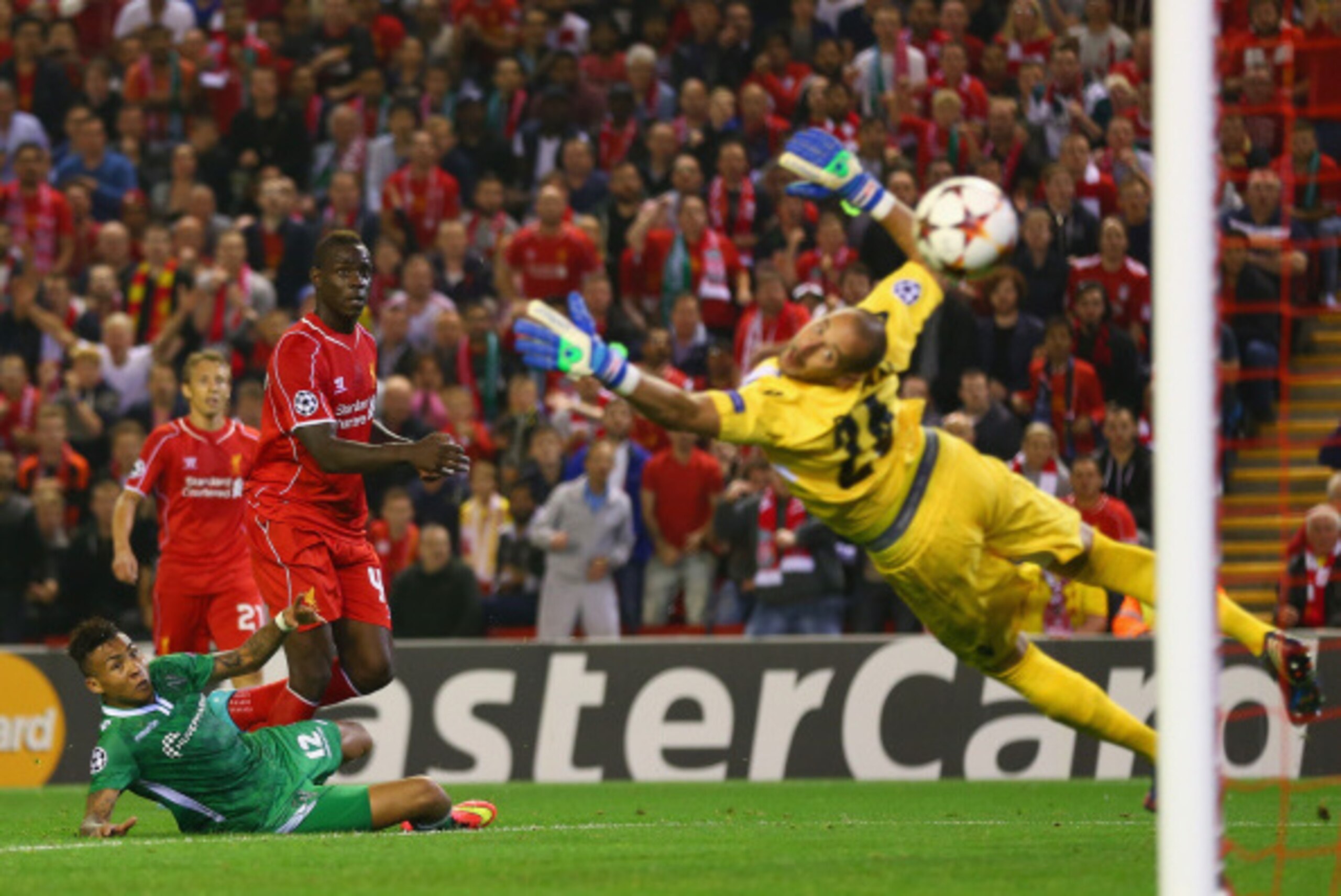 LIVERPOOL, ENGLAND - SEPTEMBER 16:  Mario Balotelli of Liverpool scores the opening goal past Milan Borjan of PFC Ludogorets Razgrad  during the UEFA Champions League Group B match between Liverpool FC and PFC Ludogorets Razgrad at Anfield on September 16