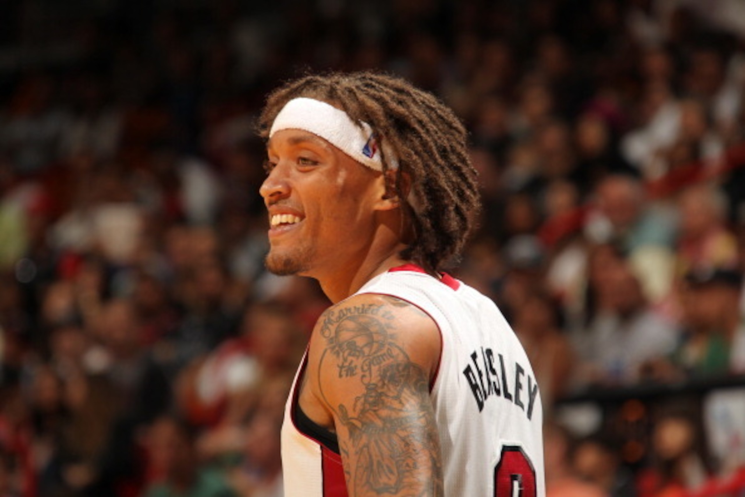MIAMI, FL - OCTOBER 19: Michael Beasley #8 of the Miami Heat looks on while smiling against the San Antonio Spurs during a game on October 19, 2013 at American Airlines Arena in Miami, Florida. NOTE TO USER: User expressly acknowledges and agrees that, by