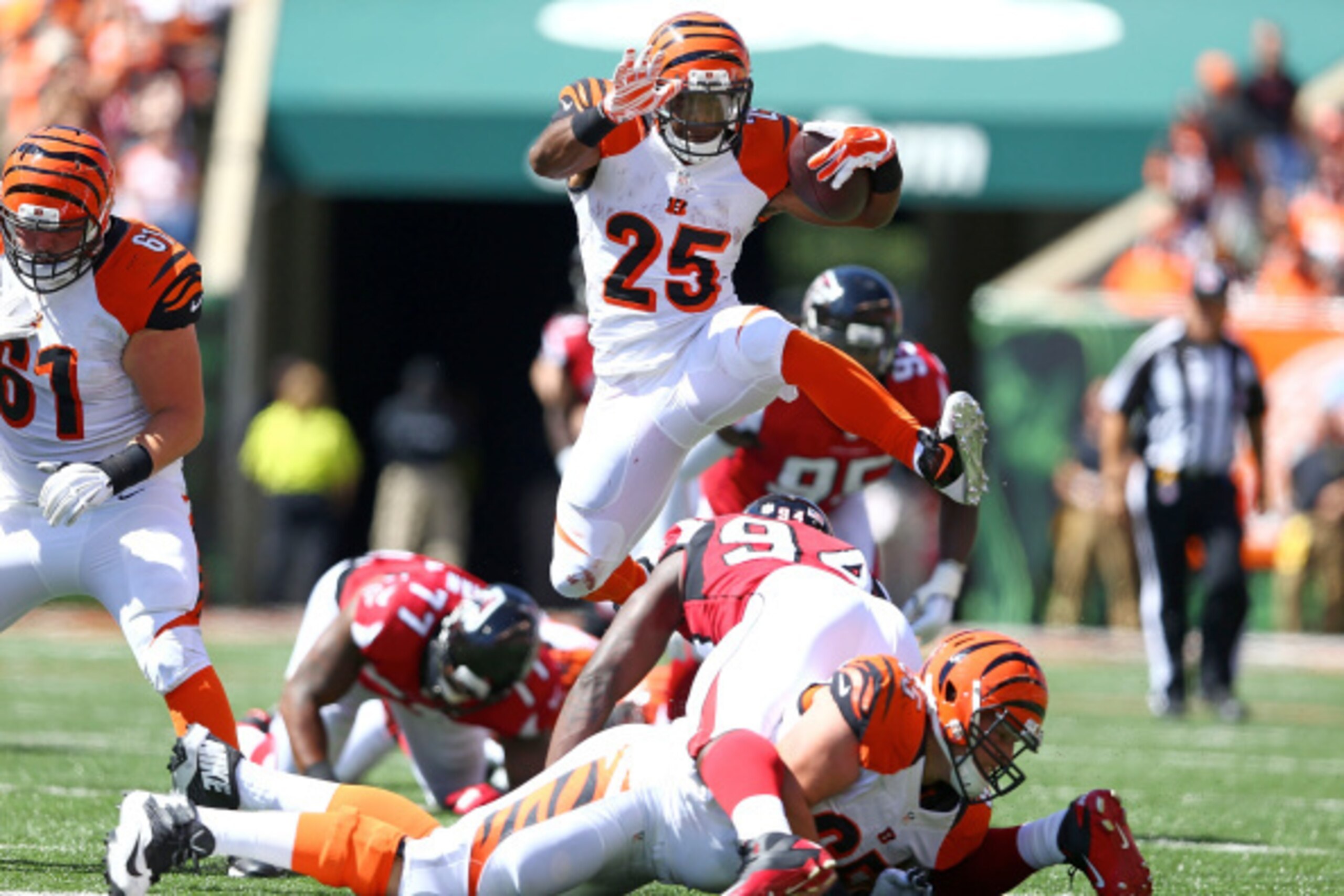 CINCINNATI, OH - SEPTEMBER 14:  Giovani Bernard #25 of the Cincinnati Bengals jumps over Jonathan Massaquoi #94 of the Atlanta Falcons during the second quarter at Paul Brown Stadium on September 14, 2014 in Cincinnati, Ohio.  (Photo by Andy Lyons/Getty I