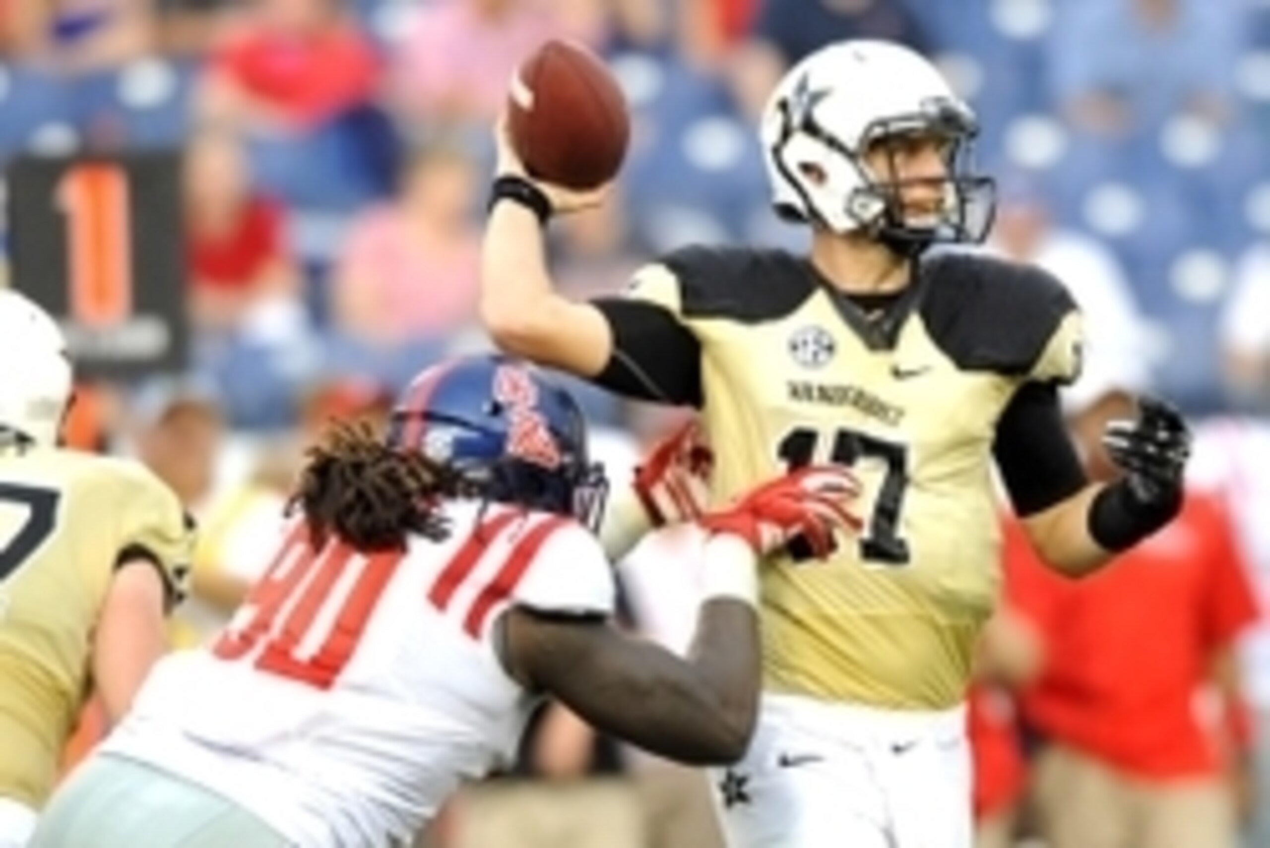 Sep 6, 2014; Nashville, TN, USA; Vanderbilt Commodores quarterback Stephen Rivers (17) is hit by Mississippi Rebels defensive end Fadol Brown (90) as he throws the ball during the second half at LP Field. Mississippi won 41-3. Mandatory Credit: Christophe