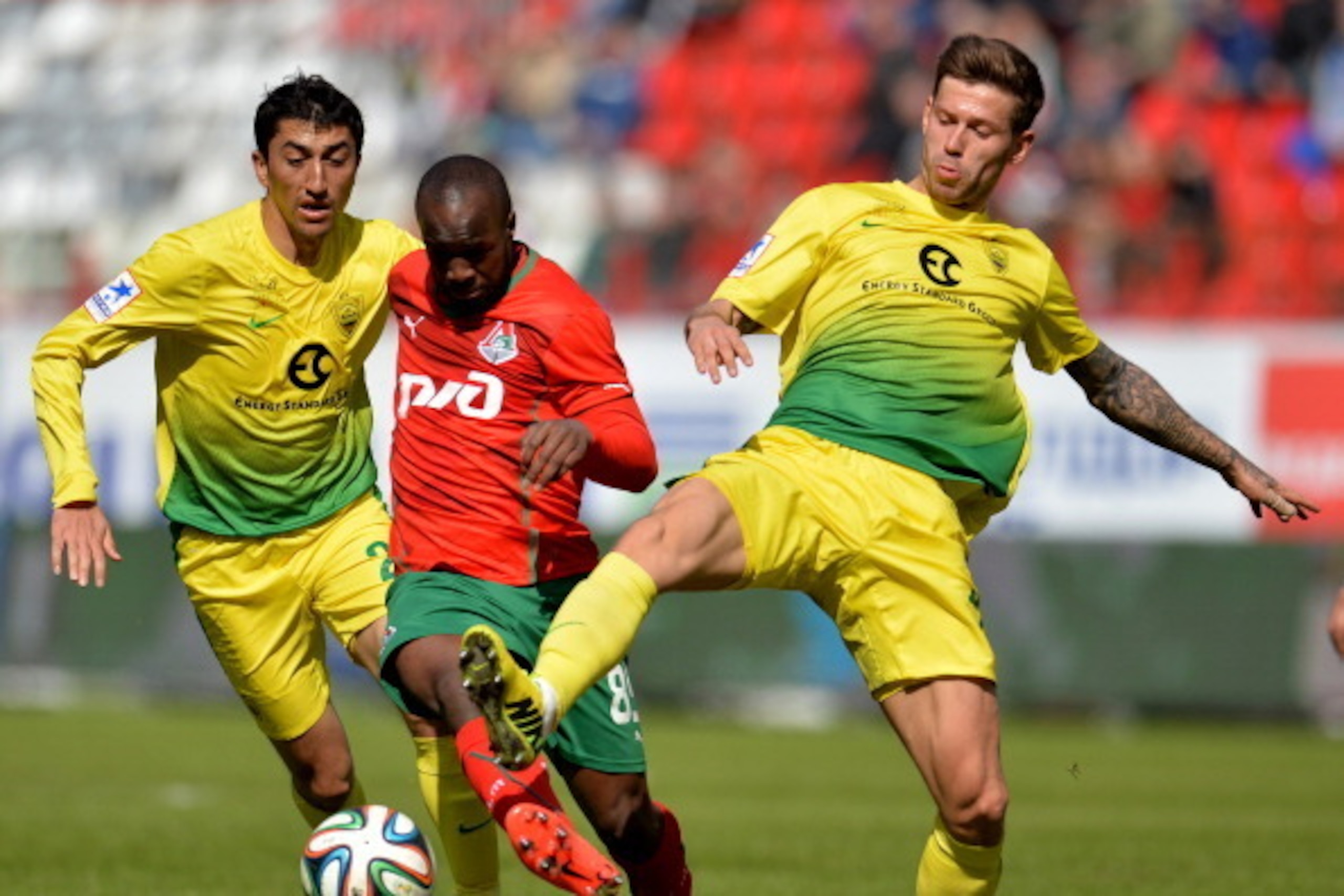 MOSCOW, RUSSIA - APRIL 13: Lassana Diarra (C) of FC Lokomotiv Moscow is challenged by Odil Ahmedov and Fyodor Smolov of FC Anzhi Makhachkala during the Russian Premier League match between FC Lokomotiv Moscow and FC Anzhi Makhachkala at Lokomotiv Stadium MOSCOW, RUSSIA - APRIL 13: Lassana Diarra (C) of FC Lokomotiv Moscow is challenged by Odil Ahmedov and Fyodor Smolov of FC Anzhi Makhachkala during the Russian Premier League match between FC Lokomotiv Moscow and FC Anzhi Makhachkala at Lokomotiv Stadium