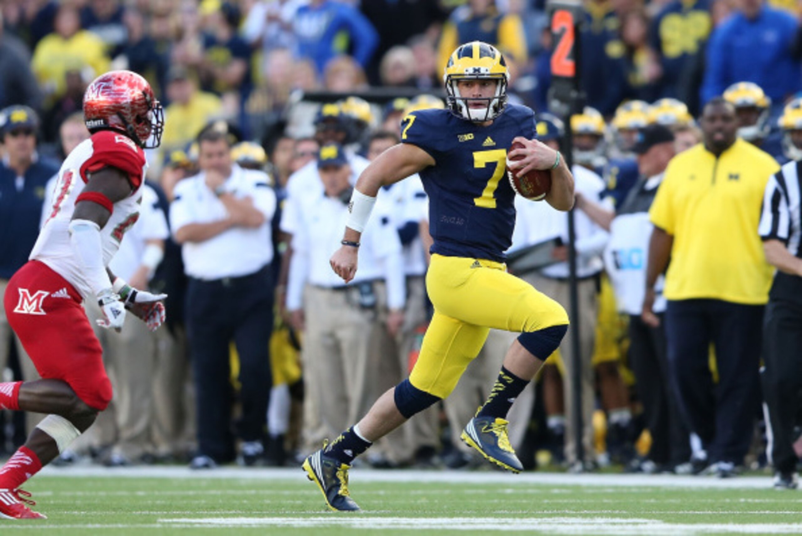 ANN ARBOR, MI - SEPTEMBER 13: Quarterback Shane Morris #7 of the University of Michigan runs for a first down during the fourth quarter of the game against the Miami University Redhawks at Michigan Stadium on September 13, 2014 in Ann Arbor, Michigan. th ANN ARBOR, MI - SEPTEMBER 13: Quarterback Shane Morris #7 of the University of Michigan runs for a first down during the fourth quarter of the game against the Miami University Redhawks at Michigan Stadium on September 13, 2014 in Ann Arbor, Michigan. th