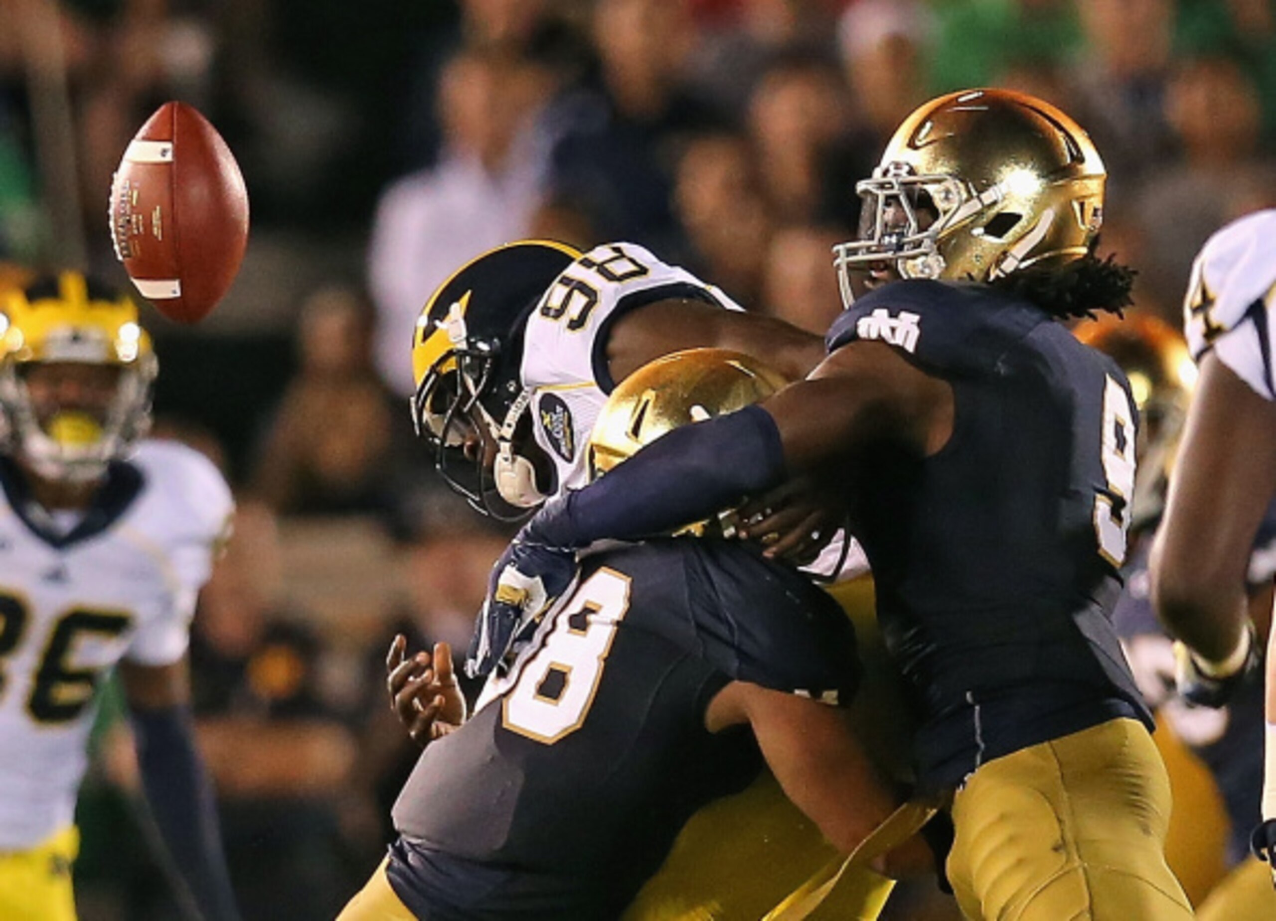 SOUTH BEND, IN - SEPTEMBER 06: Devin Gardner #98 of the Michigan Wolverines fumbles the ball as he is hit by Joe Schmidt #38 (L) abd Jaylon Smith #9 of the Notre Dame Fighting Irish at Notre Dame Stadium on September 6, 2014 in South Bend, Indiana. (Phot SOUTH BEND, IN - SEPTEMBER 06: Devin Gardner #98 of the Michigan Wolverines fumbles the ball as he is hit by Joe Schmidt #38 (L) abd Jaylon Smith #9 of the Notre Dame Fighting Irish at Notre Dame Stadium on September 6, 2014 in South Bend, Indiana. (Phot