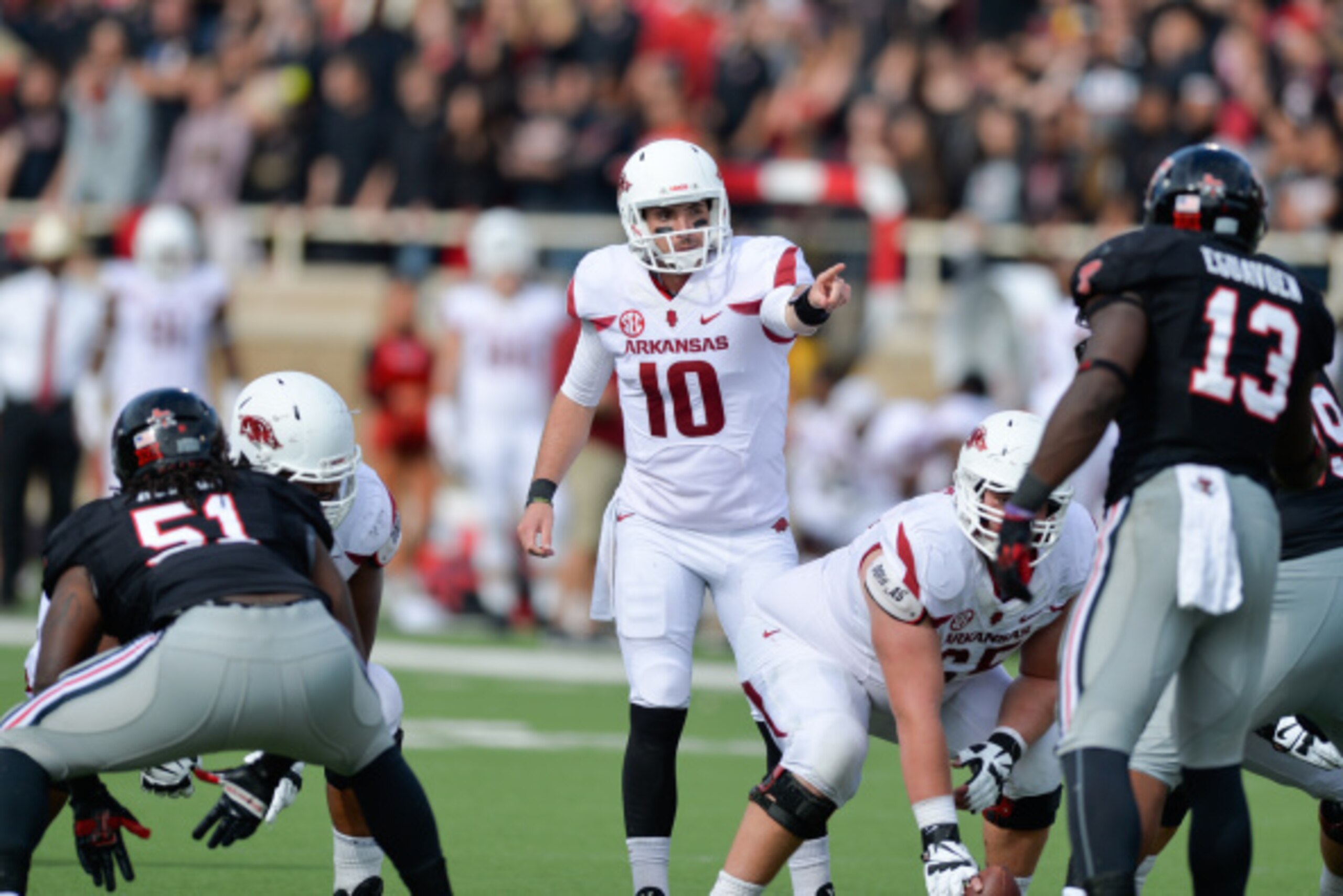 LUBBOCK, TX - SEPTEMBER 13: Brandon Allen #10 of the Arkansas Razorbacks makes calls at the line of scrimmage during game action against the Texas Tech Red Raiders on September 13, 2014 at Jones AT&T Stadium in Lubbock, Texas. Arkansas defeated Texas Tech