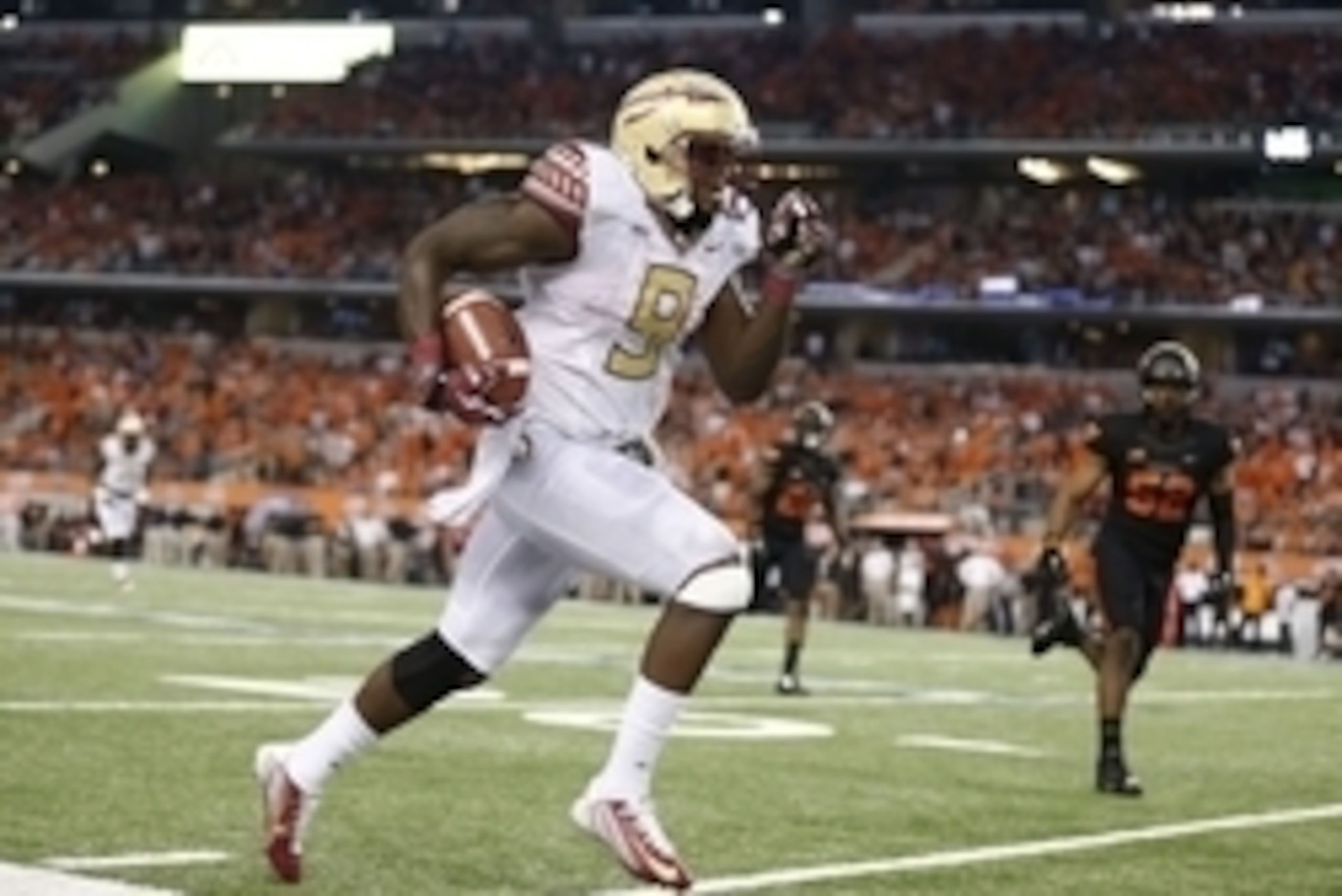 Aug 30, 2014; Arlington, TX, USA; Florida State Seminoles tailback Karlos Williams (9) runs down the sidelines against the Oklahoma State Cowboys at AT&T Stadium. The Seminoles beat the Cowboys 37-31. Mandatory Credit: Matthew Emmons-USA TODAY Sports