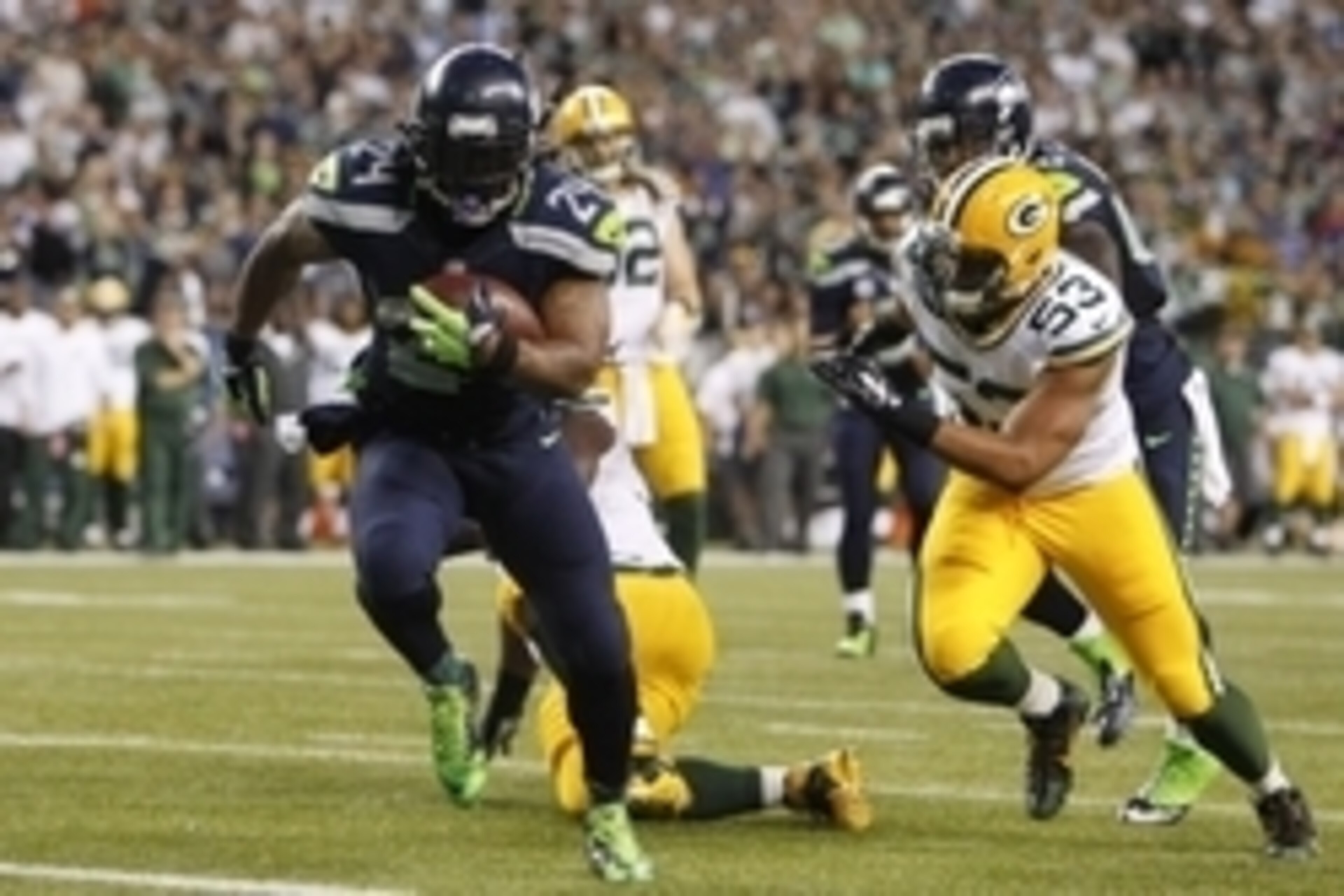 Sep 4, 2014; Seattle, WA, USA; Seattle Seahawks running back Marshawn Lynch (24) eludes a tackle by Green Bay Packers outside linebacker Nick Perry (53) to rush for a touchdown during the third quarter at CenturyLink Field. Mandatory Credit: Joe Nicholson