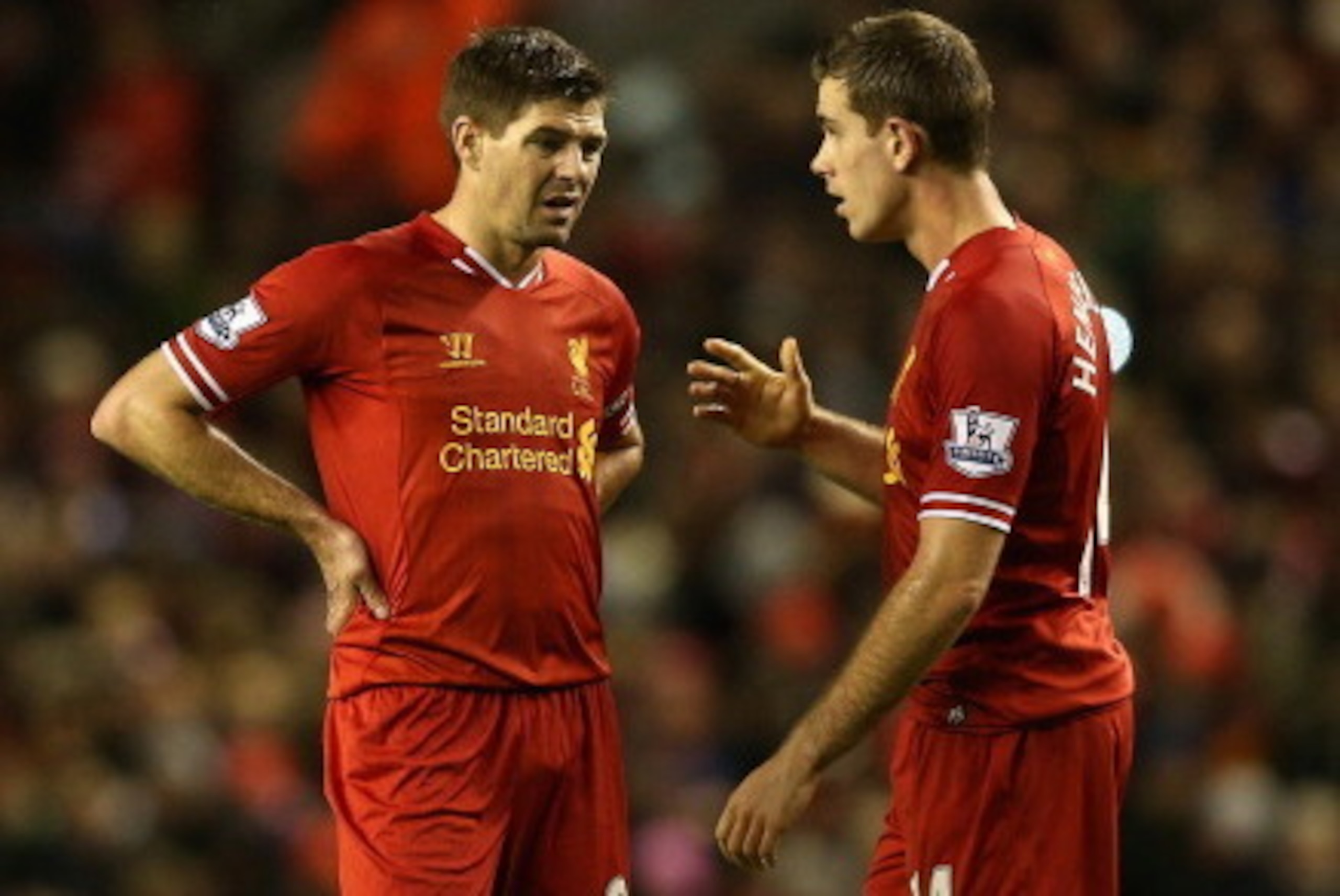 LIVERPOOL, ENGLAND - JANUARY 01: Steven Gerrard of Liverpool talks with team mate Jordan Henderson during the Barclays Premier League match between Liverpool and Hull City at Anfield on January 1, 2014 in Liverpool, England.  (Photo by Clive Brunskill/Get