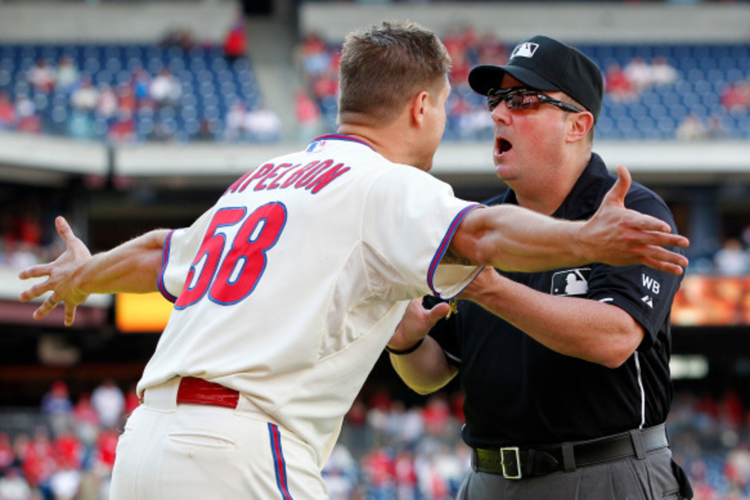 PHILADELPHIA, PA - SEPTEMBER 14: Jonathan Papelbon #58 of the Philadelphia Phillies argues with umpire Marty Foster  #60 after Papelbon was ejected from the game after making an obscene gesture while leaving the field after the final out in the ninth inni