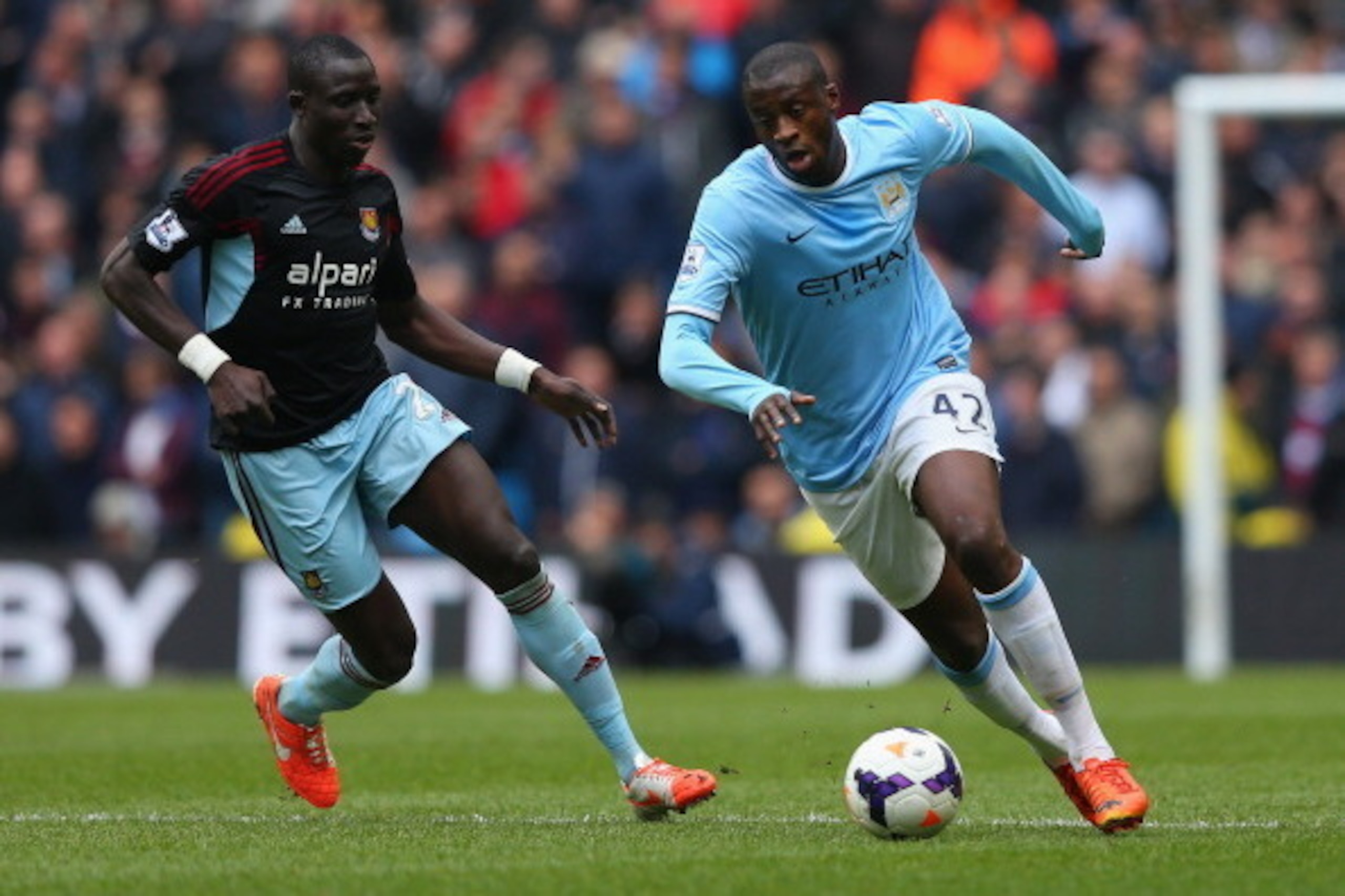 MANCHESTER, ENGLAND - MAY 11:  Yaya Toure of Manchester City competes with Mohamed Diame of West Ham United during the Barclays Premier League match between Manchester City and West Ham United at the Etihad Stadium on May 11, 2014 in Manchester, England. 
