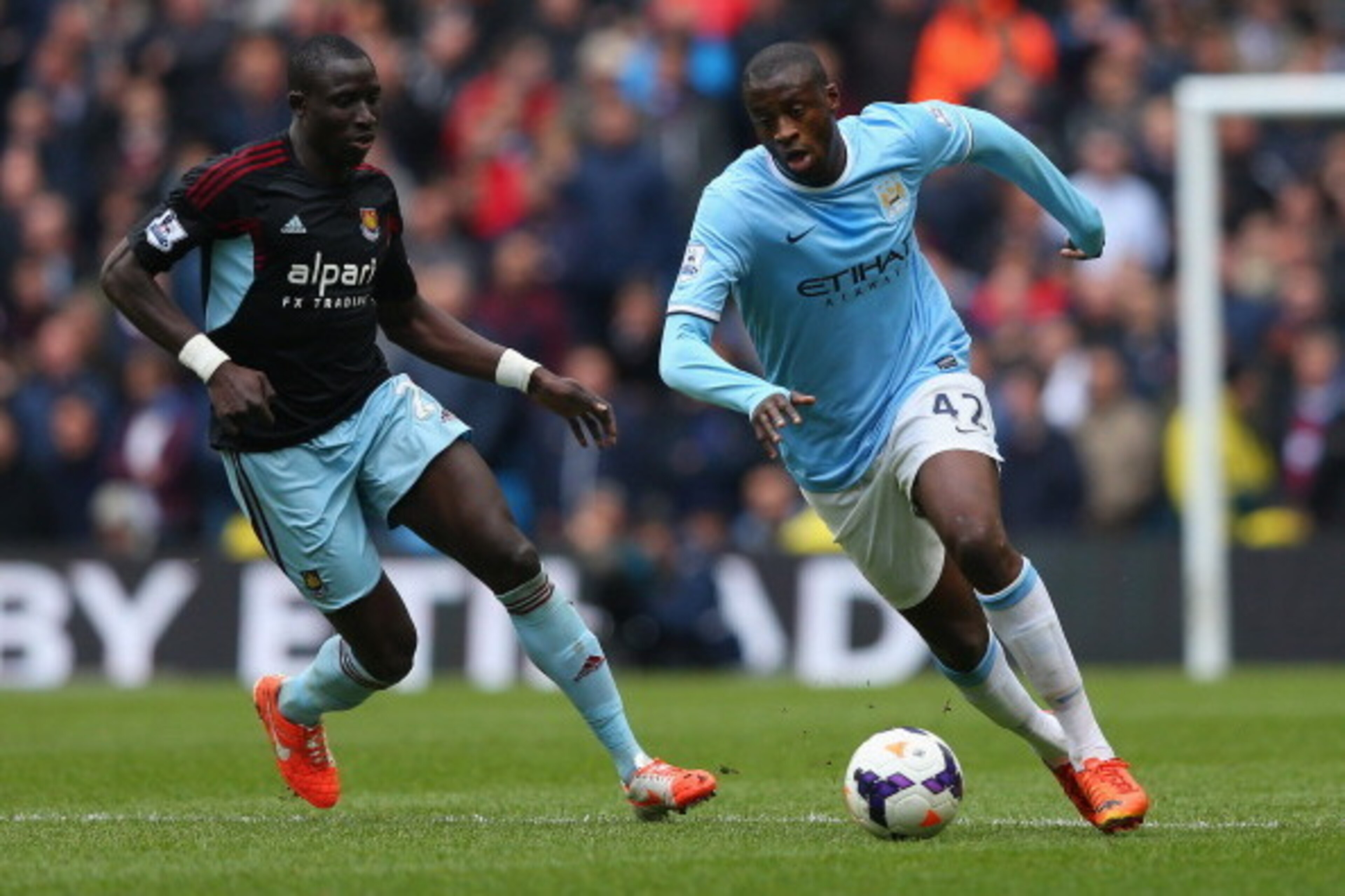 MANCHESTER, ENGLAND - MAY 11:  Yaya Toure of Manchester City competes with Mohamed Diame of West Ham United during the Barclays Premier League match between Manchester City and West Ham United at the Etihad Stadium on May 11, 2014 in Manchester, England. 
