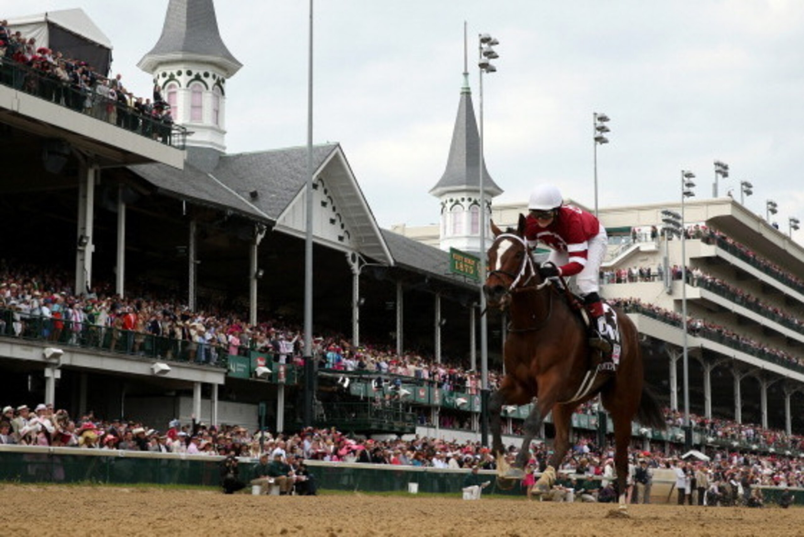 LOUISVILLE, KY - MAY 02:  Untapable #13, ridden by Rosie Napravnik, crosses the finish line to win the 140th running of the Kentucky Oaks at Churchill Downs on May 2, 2014 in Louisville, Kentucky.  (Photo by Rob Carr/Getty Images)