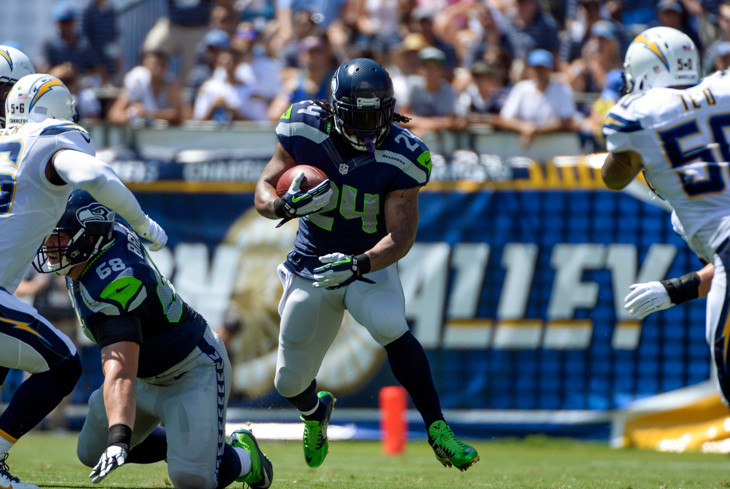Sep 14, 2014; San Diego, CA, USA; Seattle Seahawks running back Marshawn Lynch (24) carries the ball during first quarter action against the San Diego Chargers at Qualcomm Stadium. Mandatory Credit: Robert Hanashiro-USA TODAY Sports