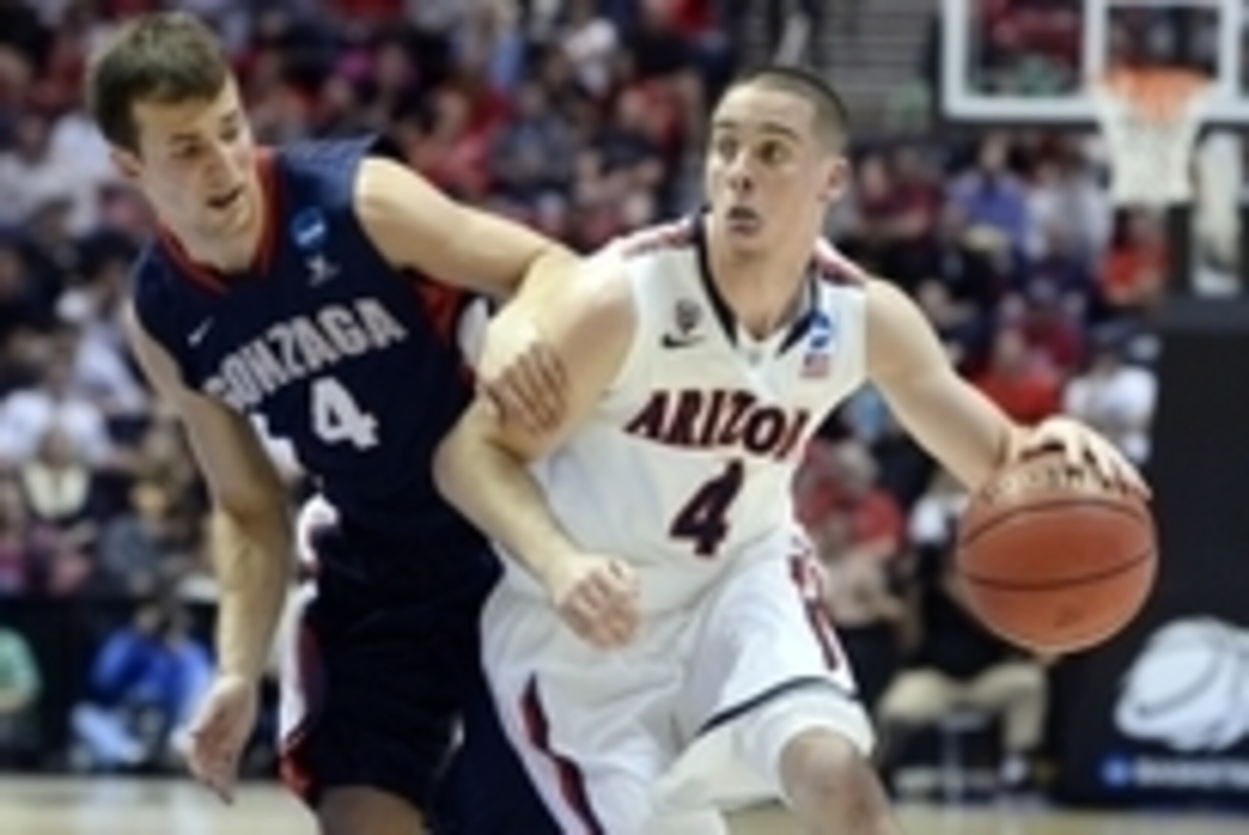 Mar 23, 2014; San Diego, CA, USA; Arizona Wildcats guard T.J. McConnell (4) drives to the basket against Gonzaga Bulldogs guard Kevin Pangos (4) in the first half of a men's college basketball game during the third round of the 2014 NCAA Tournament at Vie
