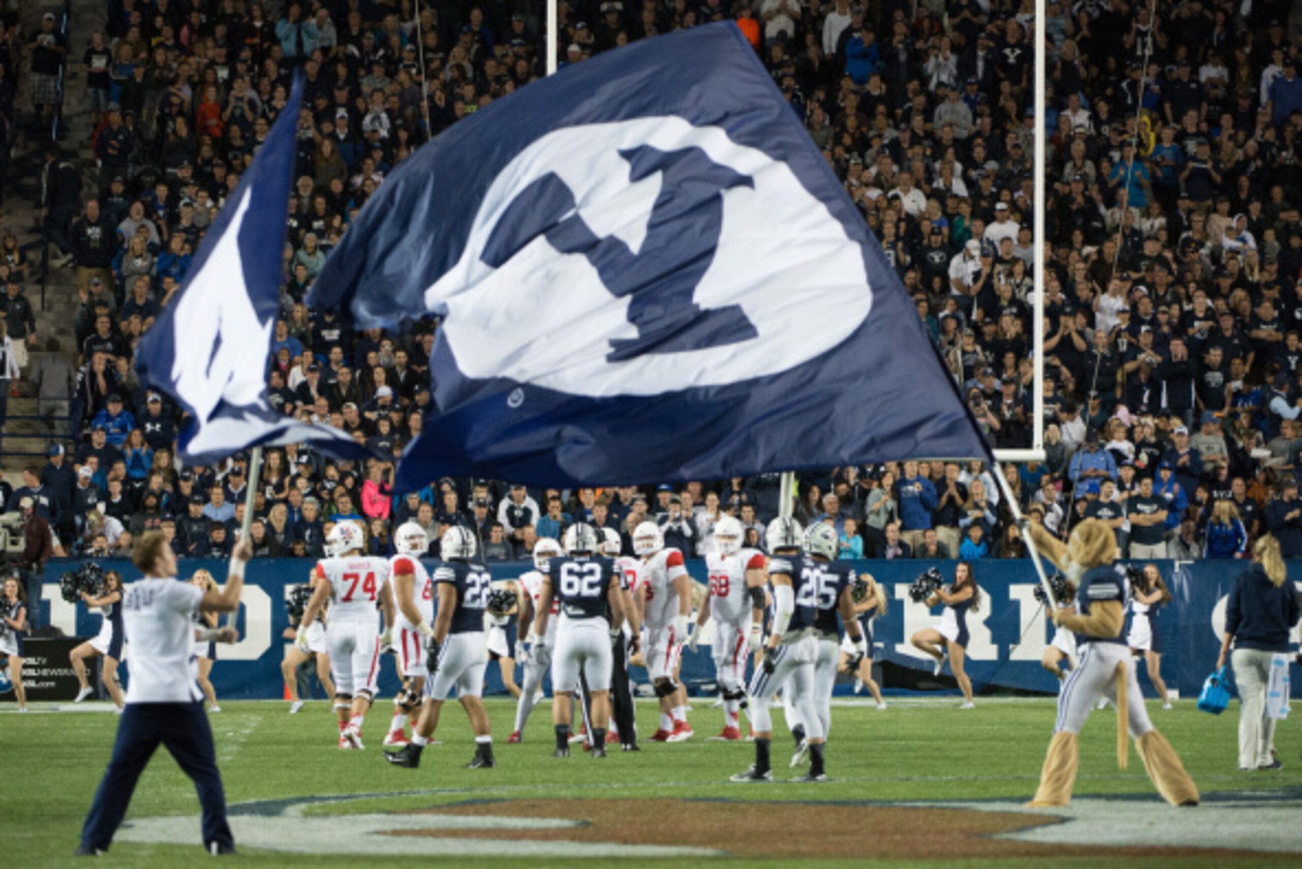 PROVO, UT - SEPTEMBER 11:  The BYU Cougars mascot and cheerleader waves a flag at midfield during a game against the Houston Cougars on September 11, 2014 at LaVell Edwards Stadium in Provo, Utah. (Photo by Jay Drowns/Getty Images)