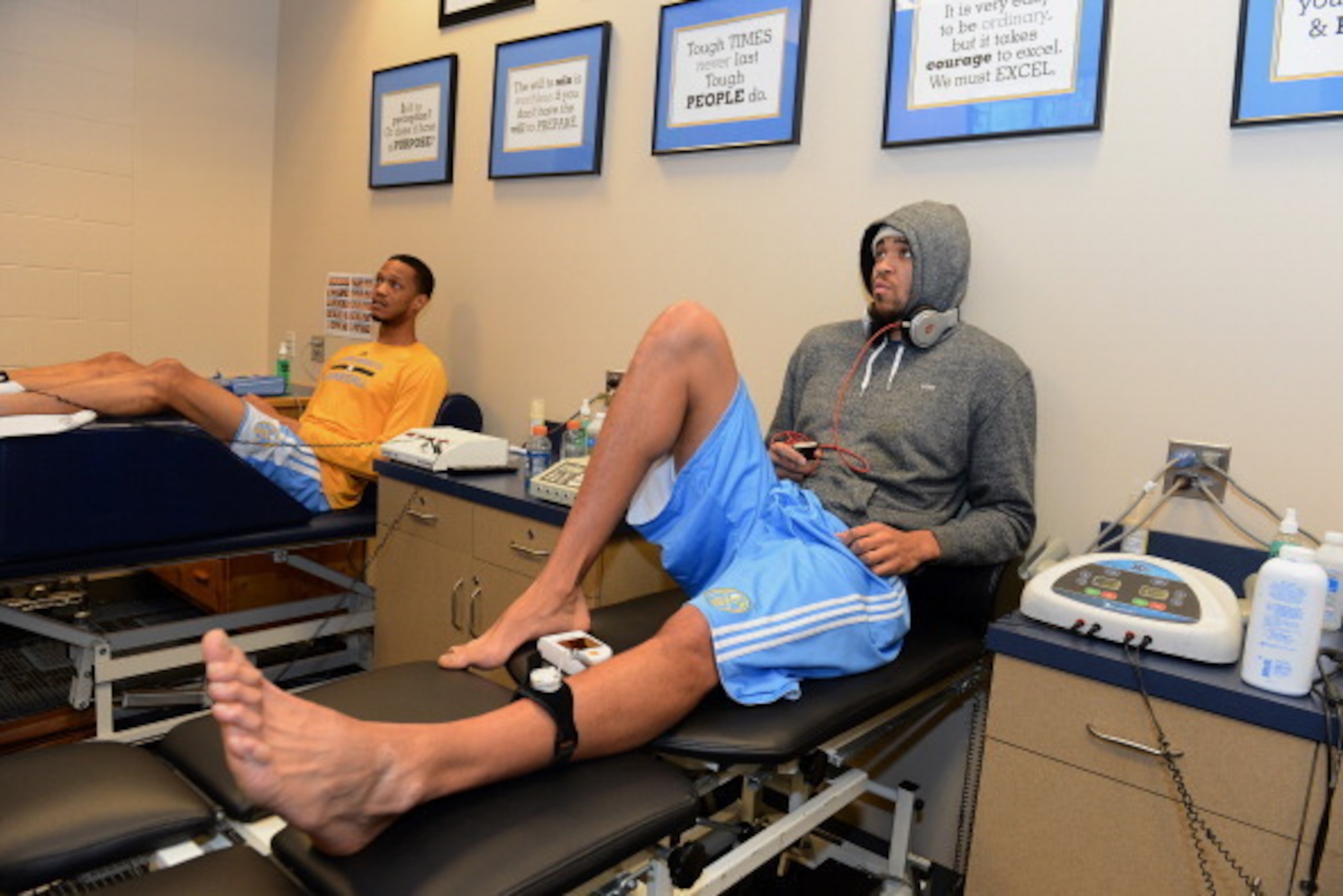 DENVER, CO - NOVEMBER 21:  JaVale McGee #34 of the Denver Nuggets gets treatment before the game against the Chicago Bulls on November 21, 2013 at the Pepsi Center in Denver, Colorado. NOTE TO USER: User expressly acknowledges and agrees that, by download