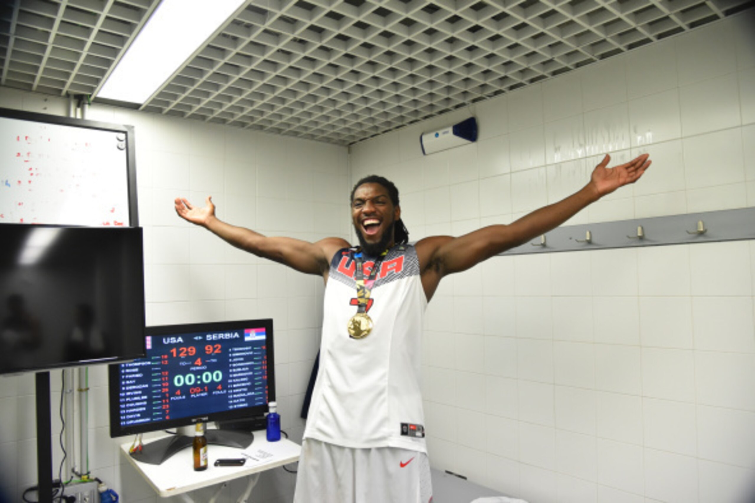 MADRID, SPAIN - SEPTEMBER 14: Kenneth Faried #7 of the USA Men's National Team poses for a photo with the gold medal as he celebrates in the locker room after defeating the Serbia National Team during the 2014 FIBA World Cup Finals at Palacio de Deportes 