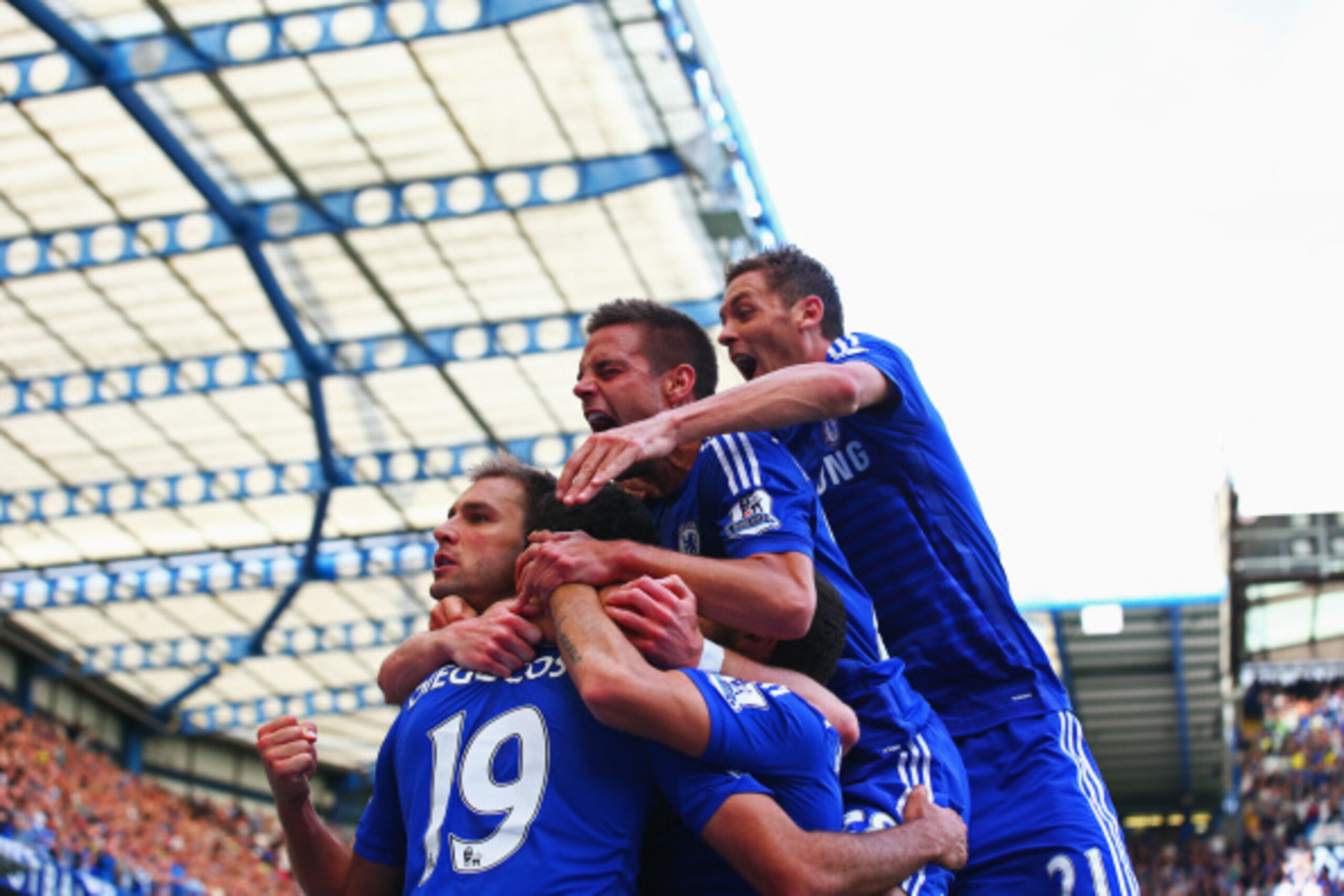 LONDON, ENGLAND - AUGUST 23:  Diego Costa of Chelsea is mobbed by team mates after scoring their first goal during the Barclays Premier League match between Chelsea and Leicester City at Stamford Bridge on August 23, 2014 in London, England.  (Photo by Pa
