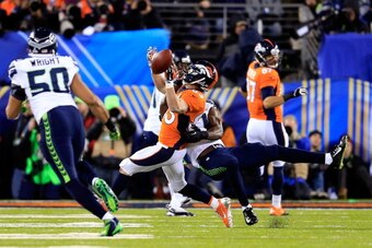 EAST RUTHERFORD, NJ - FEBRUARY 02:  Wide receiver Wes Welker #83 of the Denver Broncos attempts to catch the ball against strong safety Kam Chancellor #31 of the Seattle Seahawks in the third quarter during Super Bowl XLVIII at MetLife Stadium on February
