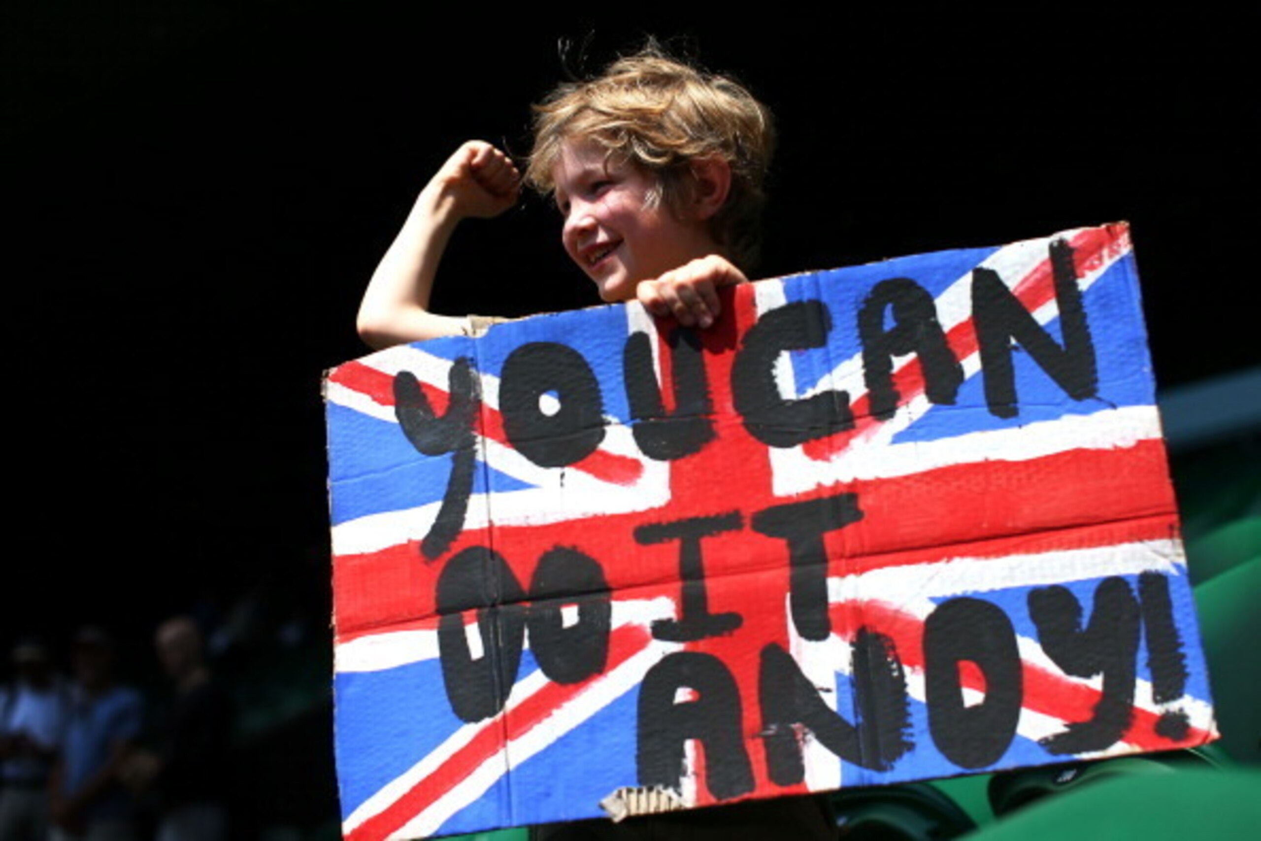 LONDON, ENGLAND - JULY 07:  A young tennis fan holds a Union Jack banner with a message of support for Andy Murray of Great Britain ahead of his Gentlemen's Singles final match against Novak Djokovic of Serbia on day thirteen of the Wimbledon Lawn Tennis 