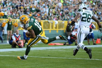GREEN BAY, WI - SEPTEMBER 14: Wide receiver Randall Cobb #18 of the Green Bay Packers receives a one yard pass past strong safety Dawan Landry #26 of the New York Jets to score in the third quarter during the NFL game at Lambeau Field on September 14, 201