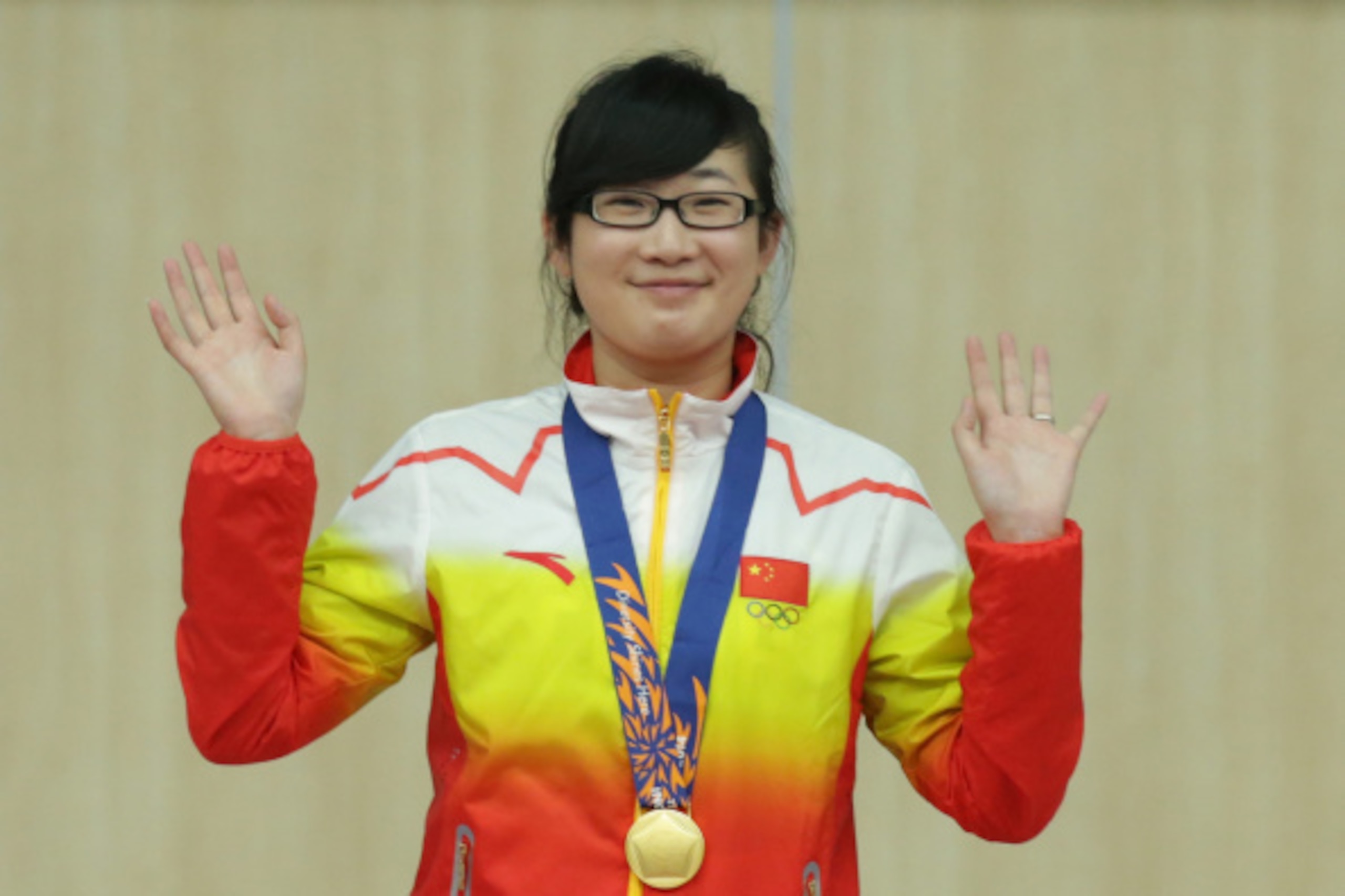 INCHEON, SOUTH KOREA - SEPTEMBER 20: Mengyuan Zhang of China celebrates winning the Gold Medal in the 10m Air Pistol Women's event at Ongnyeon International Shooting Range during the 2014 Asian Games at on September 20, 2014 in Incheon, South Korea. (Phot