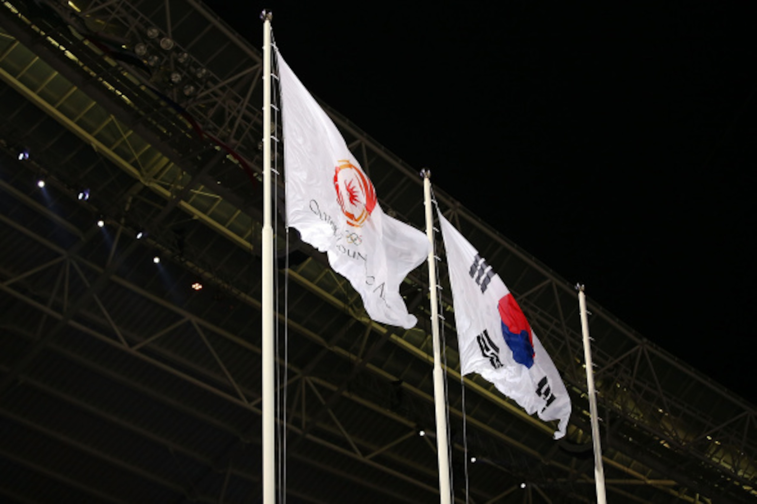 INCHEON, SOUTH KOREA - SEPTEMBER 19:  The Olympic Council of Asia and South Korea flags are raised during the Opening Ceremony ahead of the 2014 Asian Games at Incheon Asiad Main Stadium on September 19, 2014 in Incheon, South Korea.  (Photo by Brendon Th