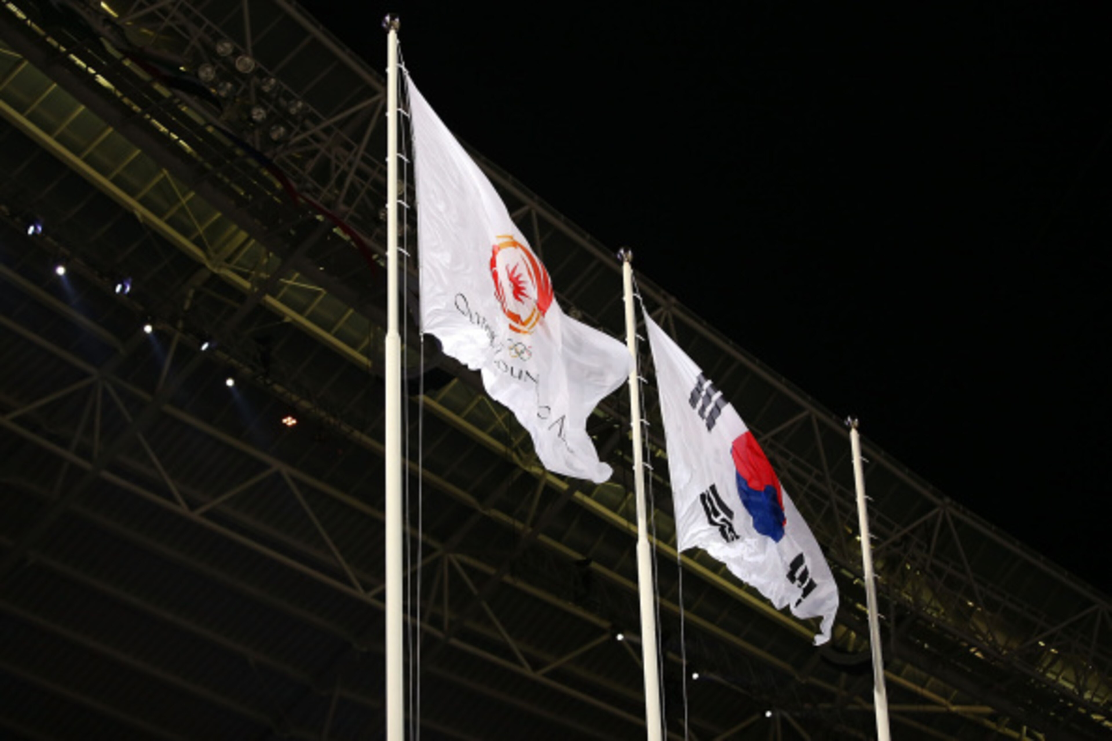 INCHEON, SOUTH KOREA - SEPTEMBER 19: The Olympic Council of Asia and South Korea flags are raised during the Opening Ceremony ahead of the 2014 Asian Games at Incheon Asiad Main Stadium on September 19, 2014 in Incheon, South Korea. (Photo by Brendon Th INCHEON, SOUTH KOREA - SEPTEMBER 19: The Olympic Council of Asia and South Korea flags are raised during the Opening Ceremony ahead of the 2014 Asian Games at Incheon Asiad Main Stadium on September 19, 2014 in Incheon, South Korea. (Photo by Brendon Th