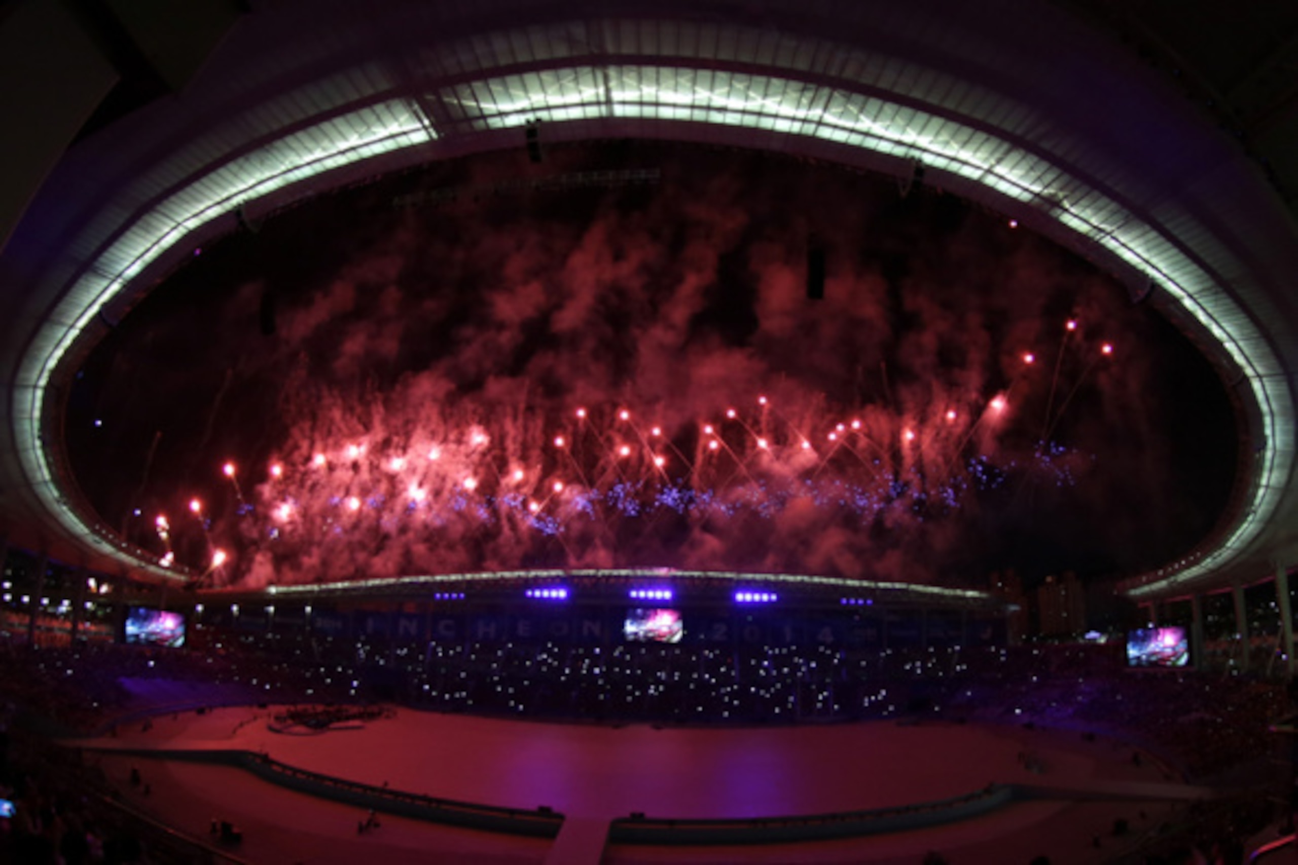 INCHEON, SOUTH KOREA - SEPTEMBER 19:  (EDITORS NOTE: THIS IMAGE WAS CREATED WITH A FISH EYE LENS) Fireworks explode during the Opening Ceremony ahead of the 2014 Asian Games at Incheon Asiad Main Stadium on September 19, 2014 in Incheon, South Korea.  (Ph