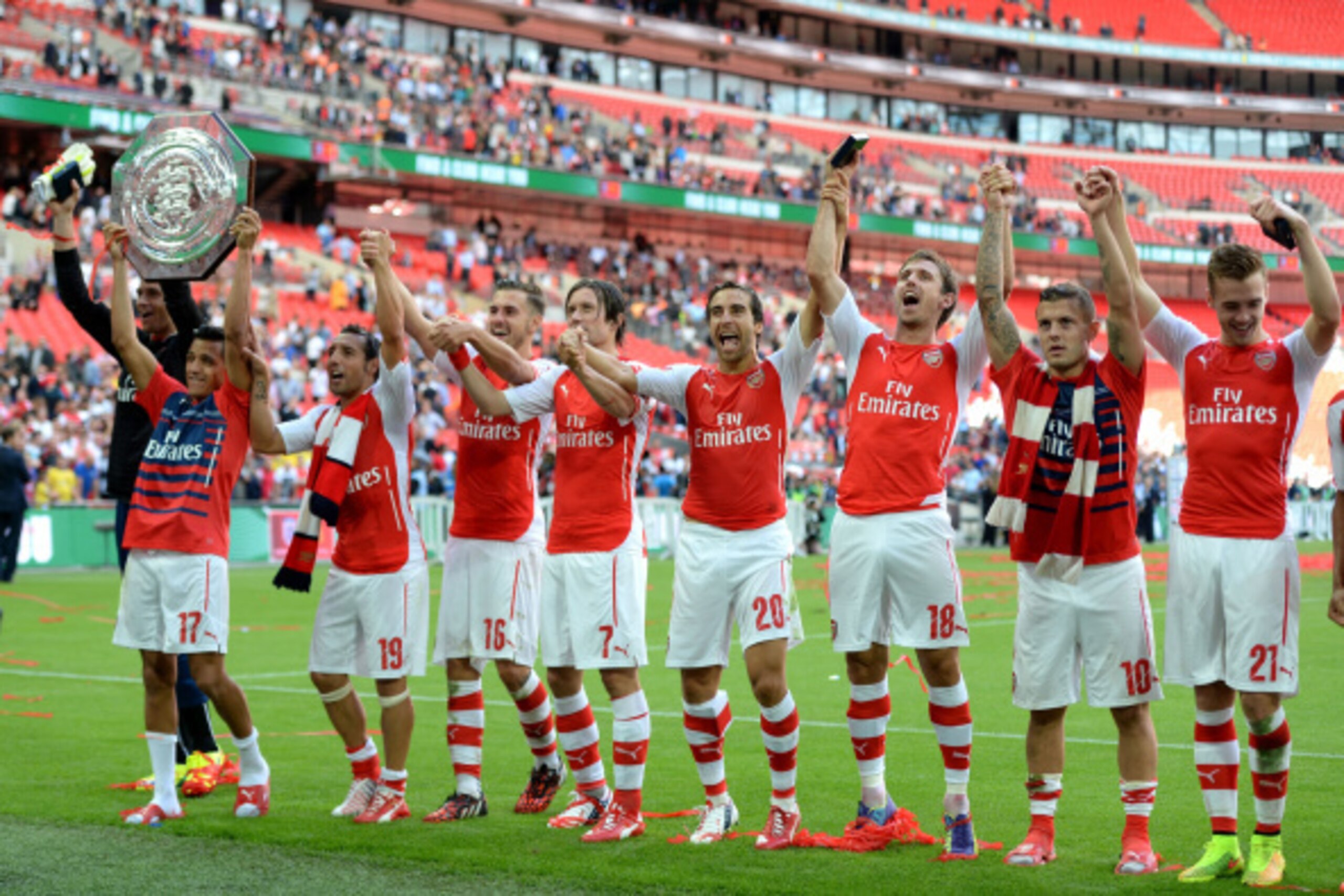 LONDON, ENGLAND - AUGUST 10:  Alexis Sanchez of Arsenal lifts the trophy next (L-R) Santi Cazorla, Aaron Ramsey, Tomas Rosicky, Mathieu Flamini, Nacho Monreal, Jack Wilshere and Calum Chambers after the FA Community Shield match between Manchester City an