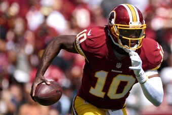LANDOVER, MD - SEPTEMBER 14: Quarterback Robert Griffin III #10 of the Washington Redskins rushes against the Jacksonville Jaguars in the first half at FedExField on September 14, 2014 in Landover, Maryland. The Washington Redskins won, 41-10. (Photo by P