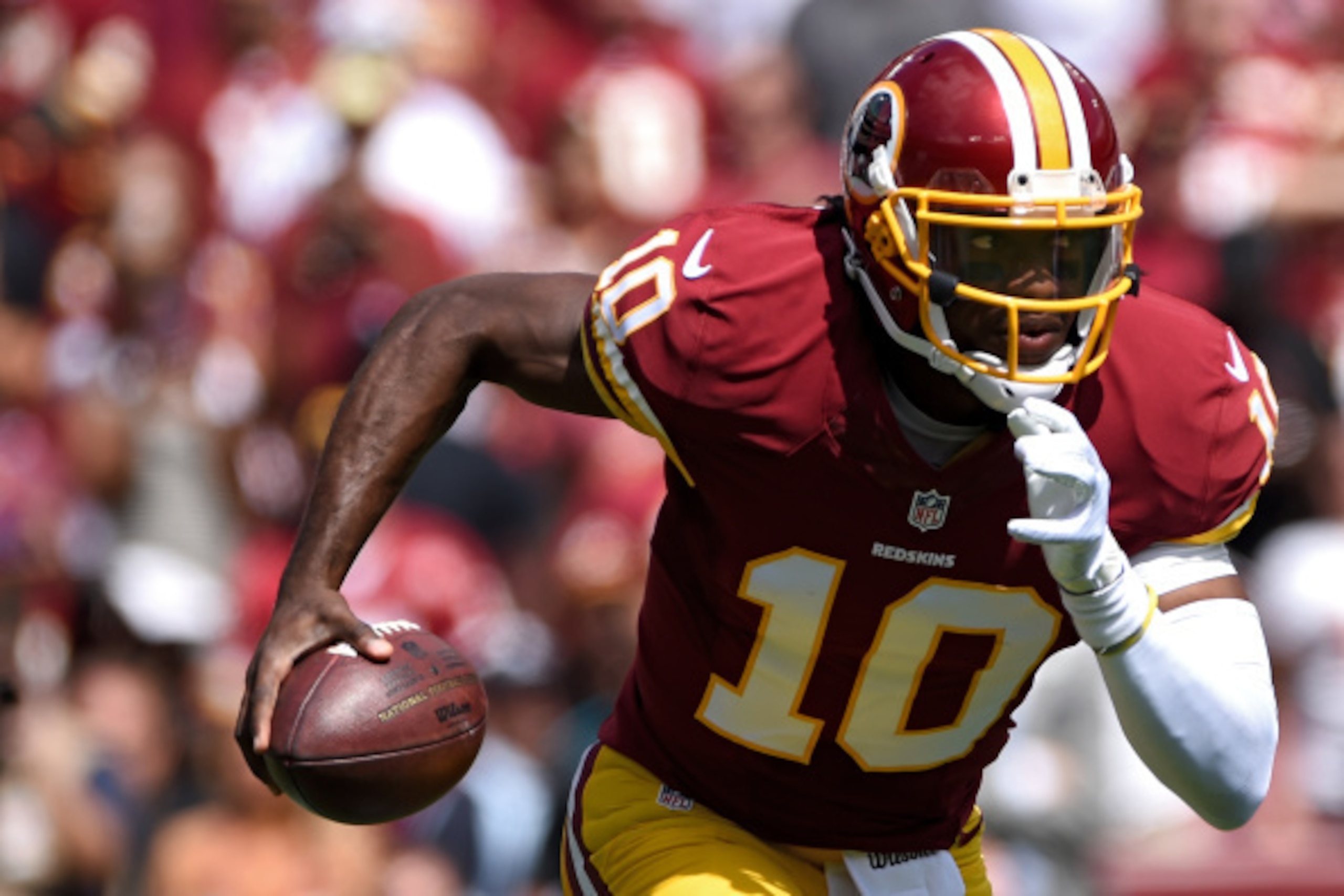 LANDOVER, MD - SEPTEMBER 14: Quarterback Robert Griffin III #10 of the Washington Redskins rushes against the Jacksonville Jaguars in the first half at FedExField on September 14, 2014 in Landover, Maryland. The Washington Redskins won, 41-10. (Photo by P