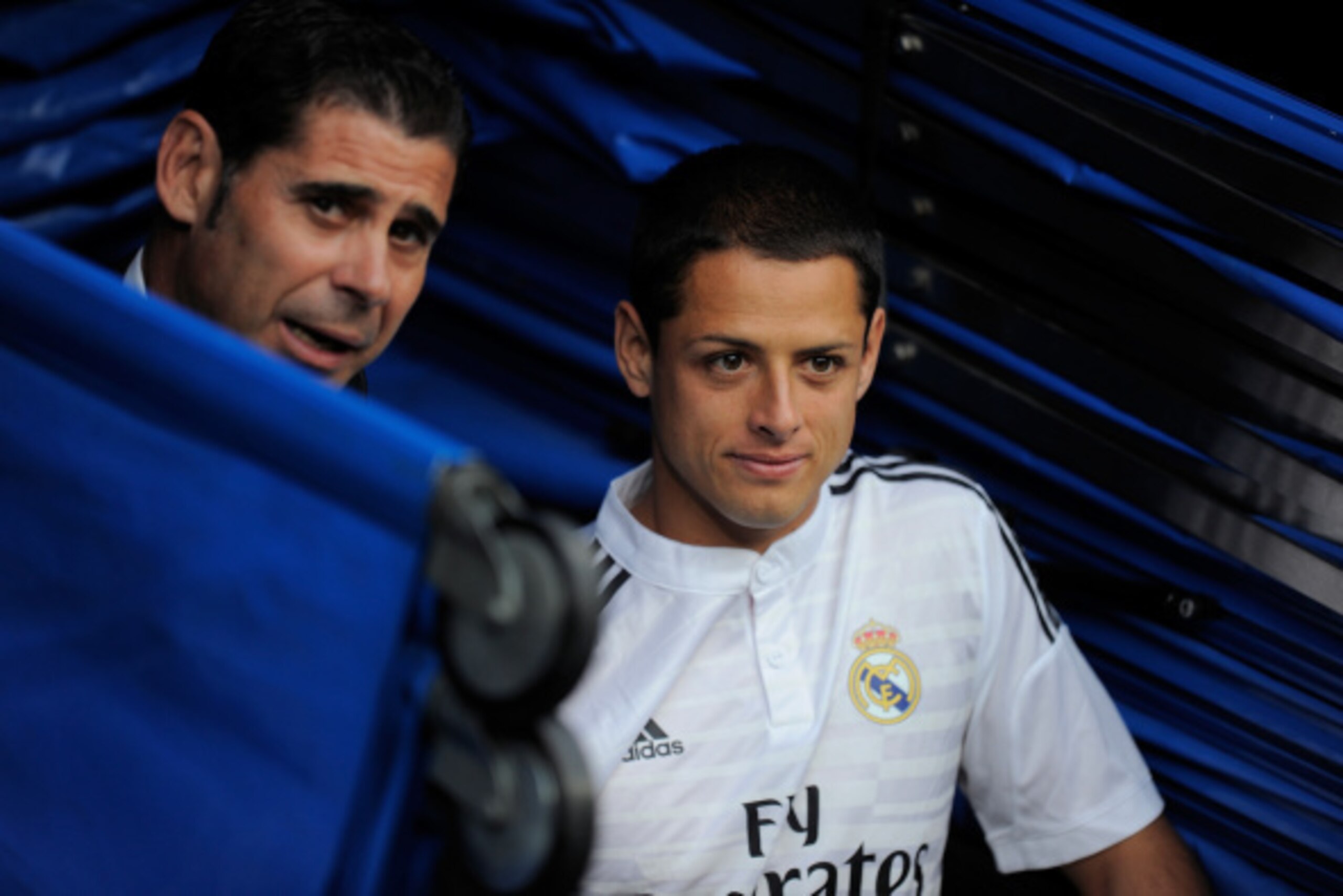 MADRID, SPAIN - SEPTEMBER 13:  Assistant coach Fernando Hierro of Real Madrid chats with newly signed Javier 'Chicharito' Hernandez from the players tunnel prior to the La Liga match between Real Madrid and Atletico de Madrid at Estadio Santiago Bernabeu 