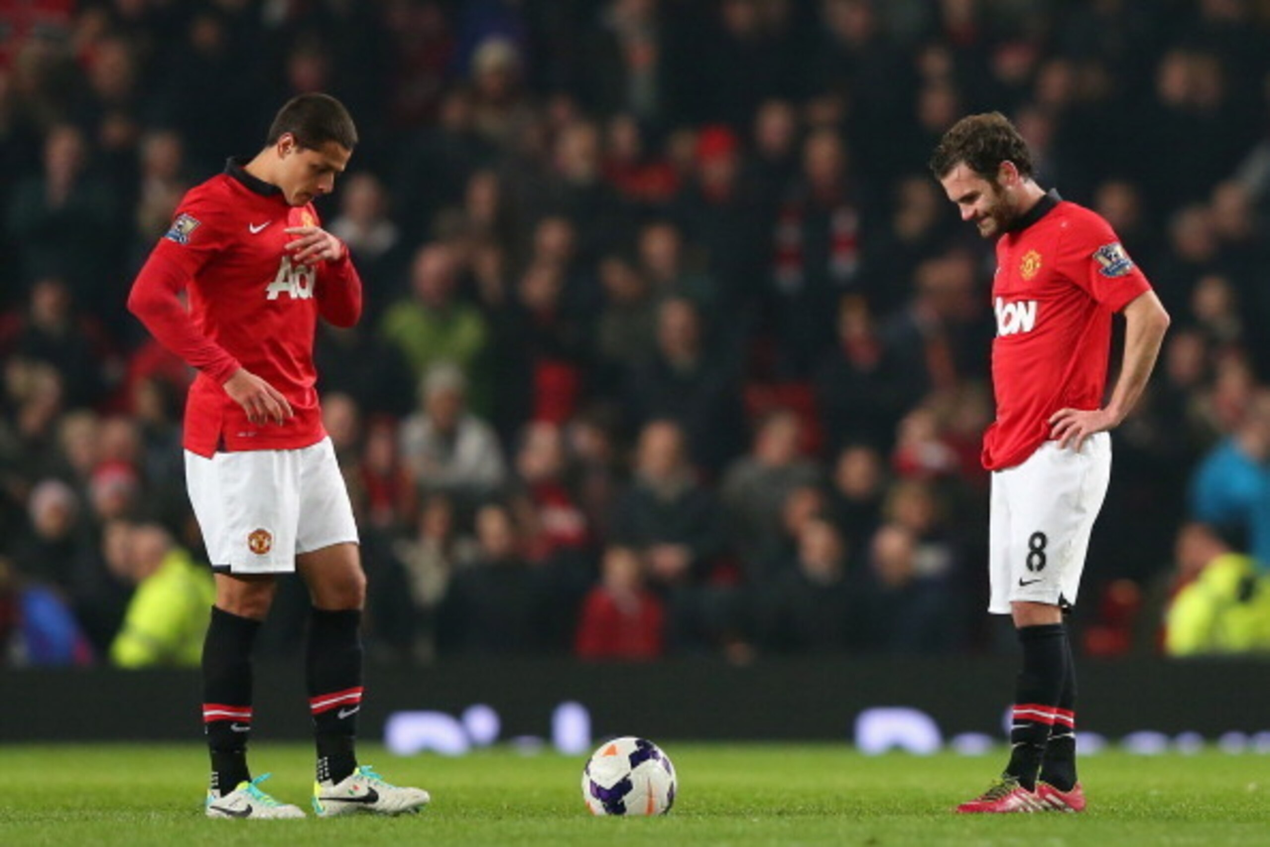 MANCHESTER, ENGLAND - MARCH 25:   Javier Hernandez of Manchester United and team-mate Juan Mata (R) look dejected after conceding the third goal during the Barclays Premier League match between Manchester United and Manchester City at Old Trafford on Marc