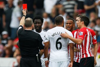 SWANSEA, WALES - SEPTEMBER 20:  Wilfried Bony of Swansea City is shown the red card by referee Jonathan Moss during the Barclays Premier League match between Swansea City and Southampton at Liberty Stadium on September 20, 2014 in Swansea, Wales.  (Photo 