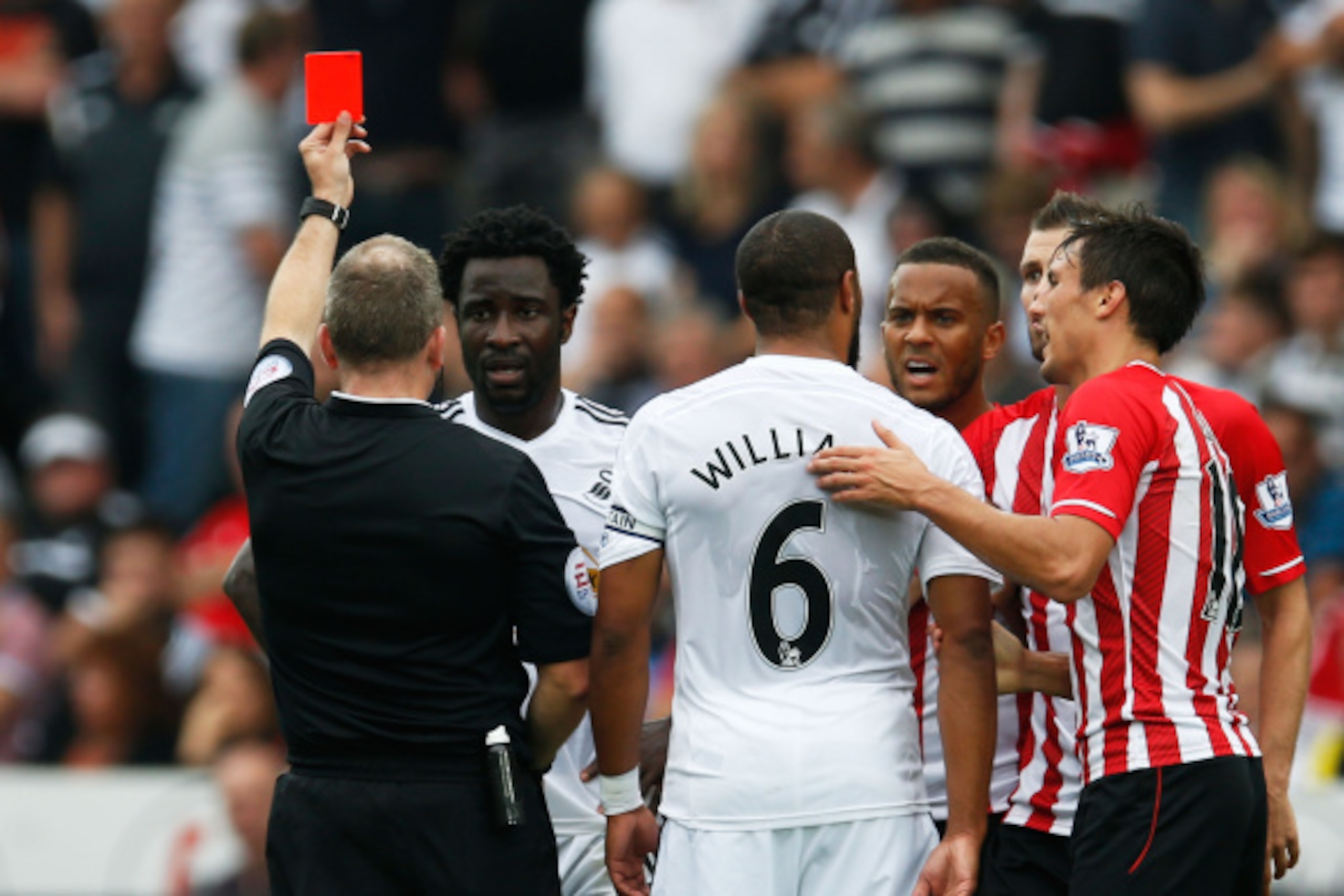 SWANSEA, WALES - SEPTEMBER 20:  Wilfried Bony of Swansea City is shown the red card by referee Jonathan Moss during the Barclays Premier League match between Swansea City and Southampton at Liberty Stadium on September 20, 2014 in Swansea, Wales.  (Photo 