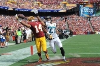 Sep 14, 2014; Landover, MD, USA; Washington Redskins wide receiver Ryan Grant (14) is unable to control the ball as Jacksonville Jaguars cornerback Dwayne Gratz (27) defends during the second half at FedEx Field. Mandatory Credit: Brad Mills-USA TODAY Spo